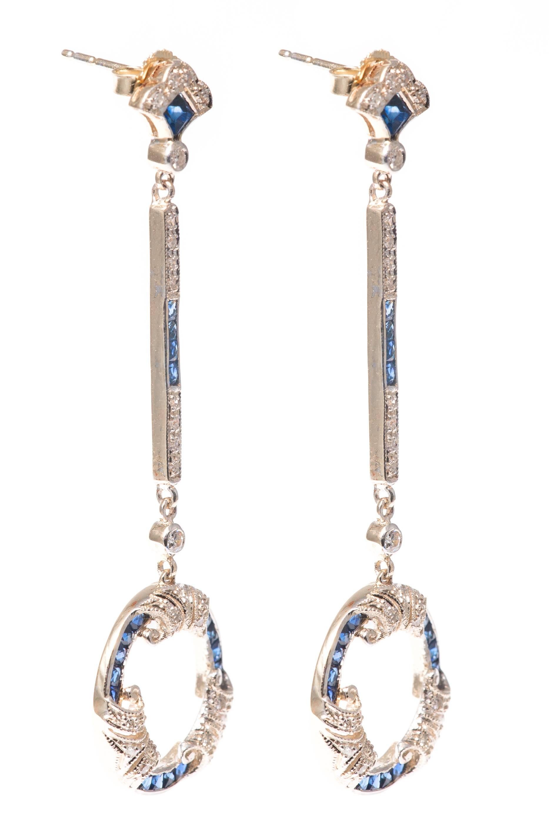 Beacon Hill Jewelers Presents:

A beautiful pair of platinum topped french cut sapphire and diamond earrings in yellow gold.  Set with beautiful rich vivid blue French cut sapphires these earrings also feature numerous pave and bezel set antique