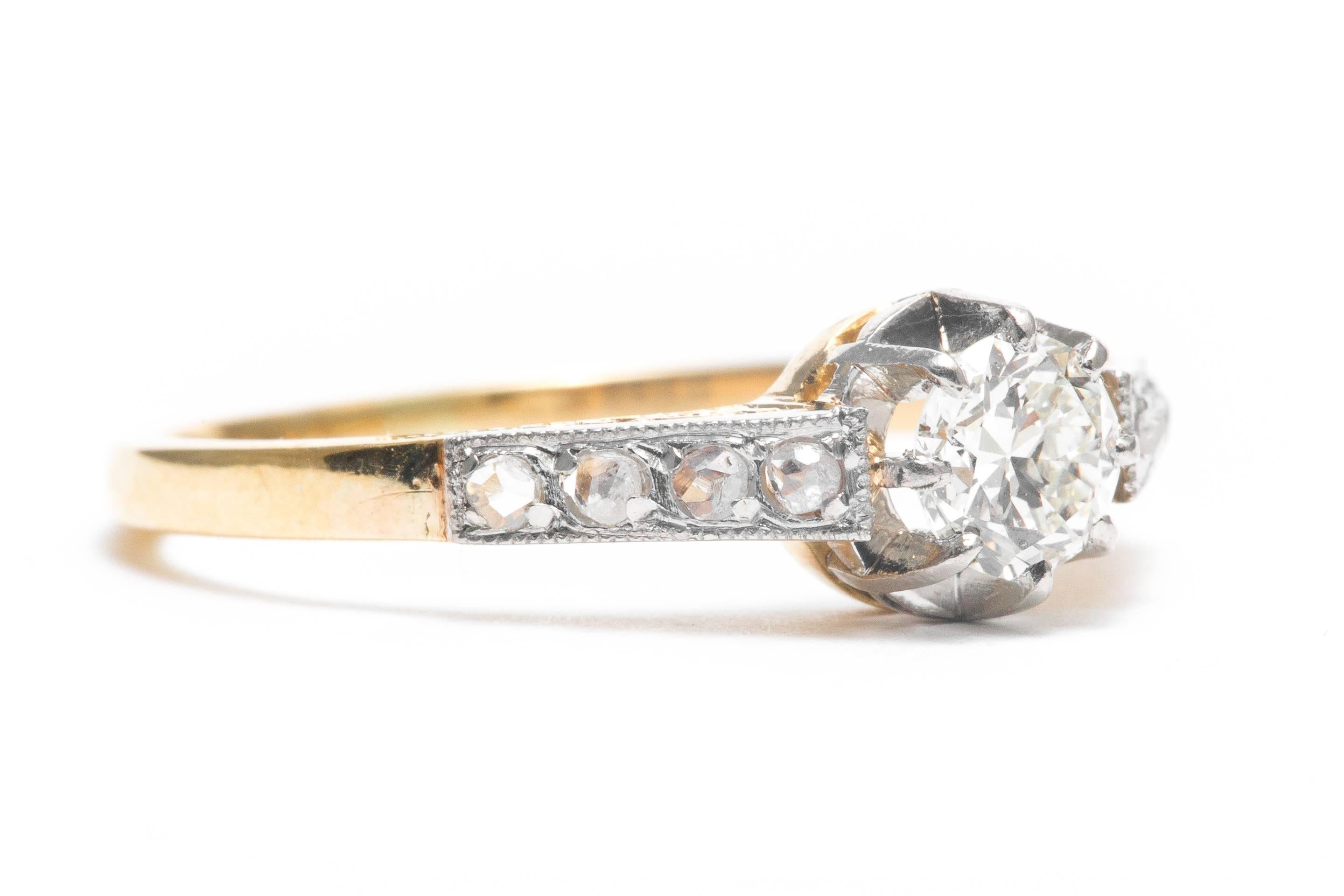 Beacon Hill Jewelers Presents:

An original art deco period diamond engagement ring in 18 karat yellow gold and platinum.  Centered by a 0.40 carat antique European cut diamond framed by rose cut diamonds, this ring features hand engraving on the