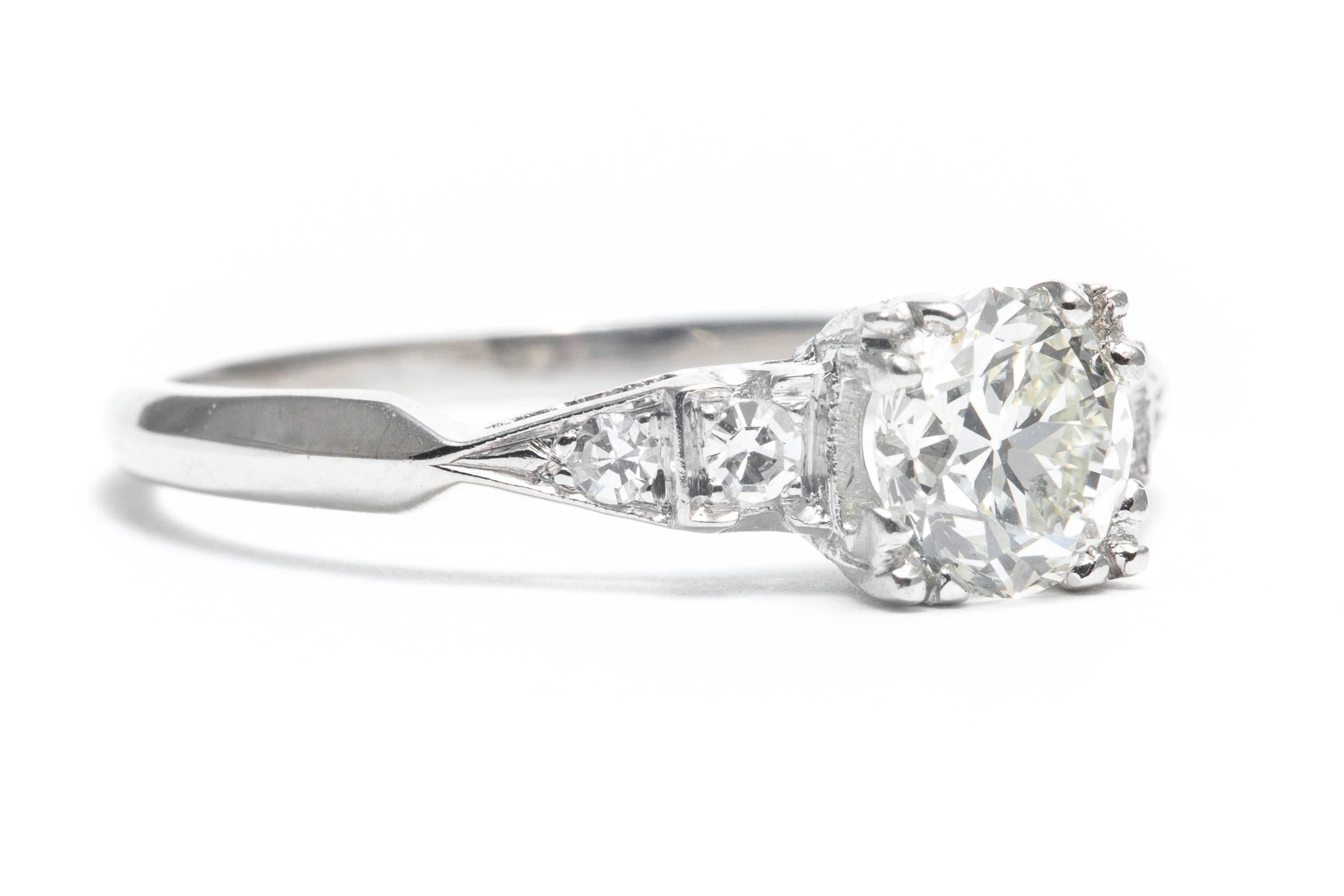 An original art deco period diamond engagement ring set in luxurious platinum.  Centered by a high quality antique European cut diamond, this ring features a traditional geometric art deco design accented by Swiss cut diamonds.

Grading as VS1