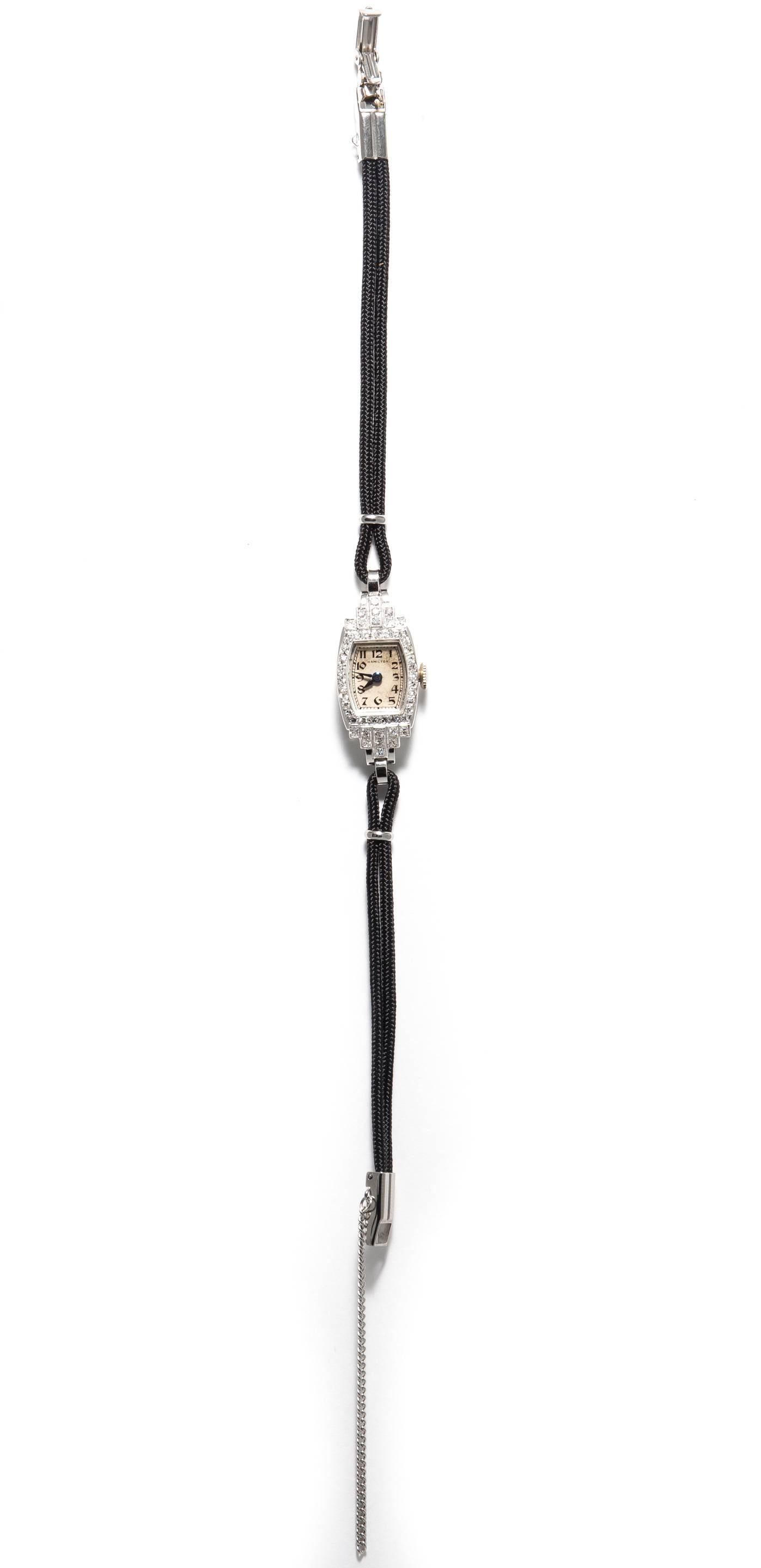 An art deco period ladies platinum, and diamond Hamilton wrist watch.  Set throughout with forty eight Swiss cut diamonds, this watch also features a stylish black woven silk cord strap that can be adjusted to fit any size wrist on request.

In