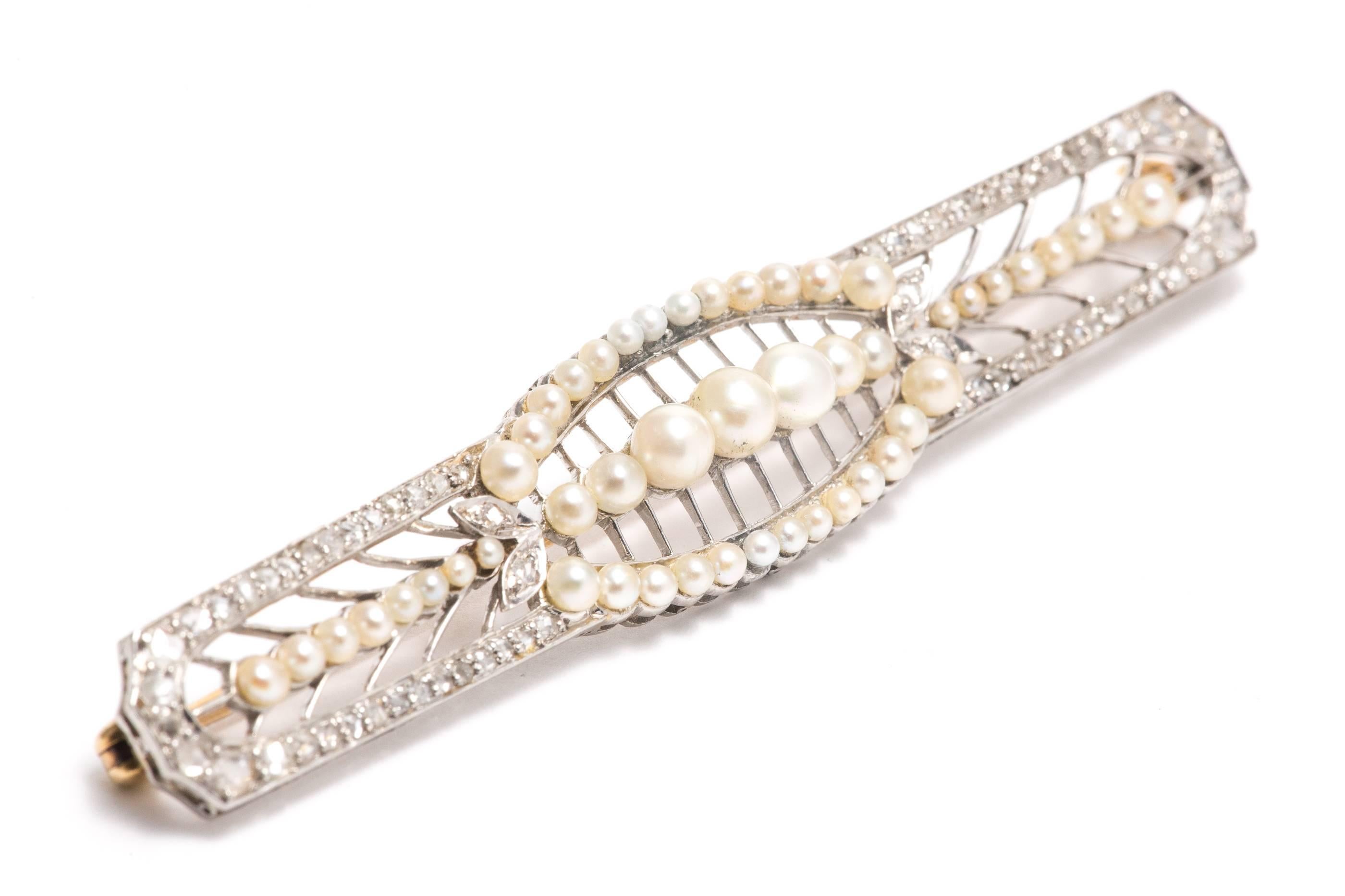 A beautiful natural pearl, and rose cut diamond brooch in platinum.  Featuring graduated natural pearls accented by pave set rose cut diamonds, this piece comes from the famous jewelers Lambert Brothers.

Grading as beautiful VS clarity and G color,