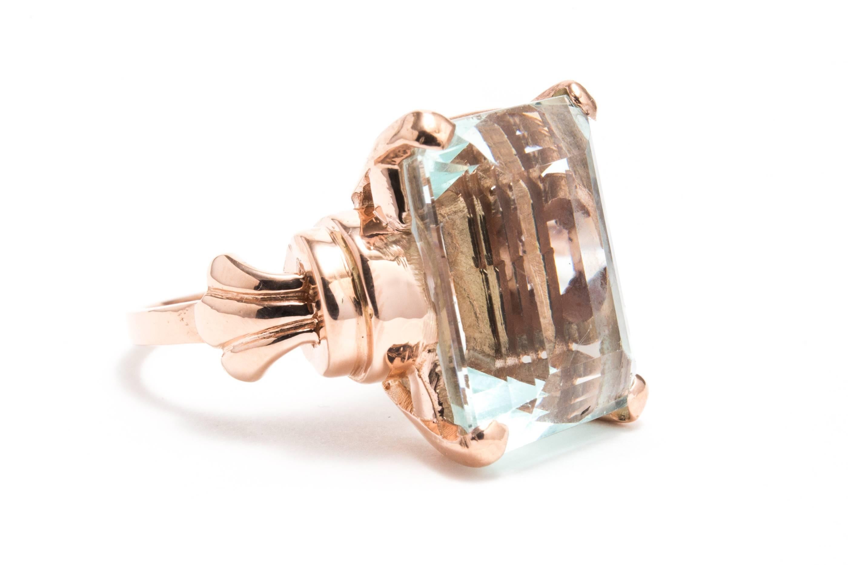 A beautiful original retro period rose gold and aquamarine solitaire ring.  Centered by a large, 14.34 carat emerald cut aquamarine, this ring features a classic handmade rose gold mounting in a traditional retro style.

Of beautiful VVS clarity and