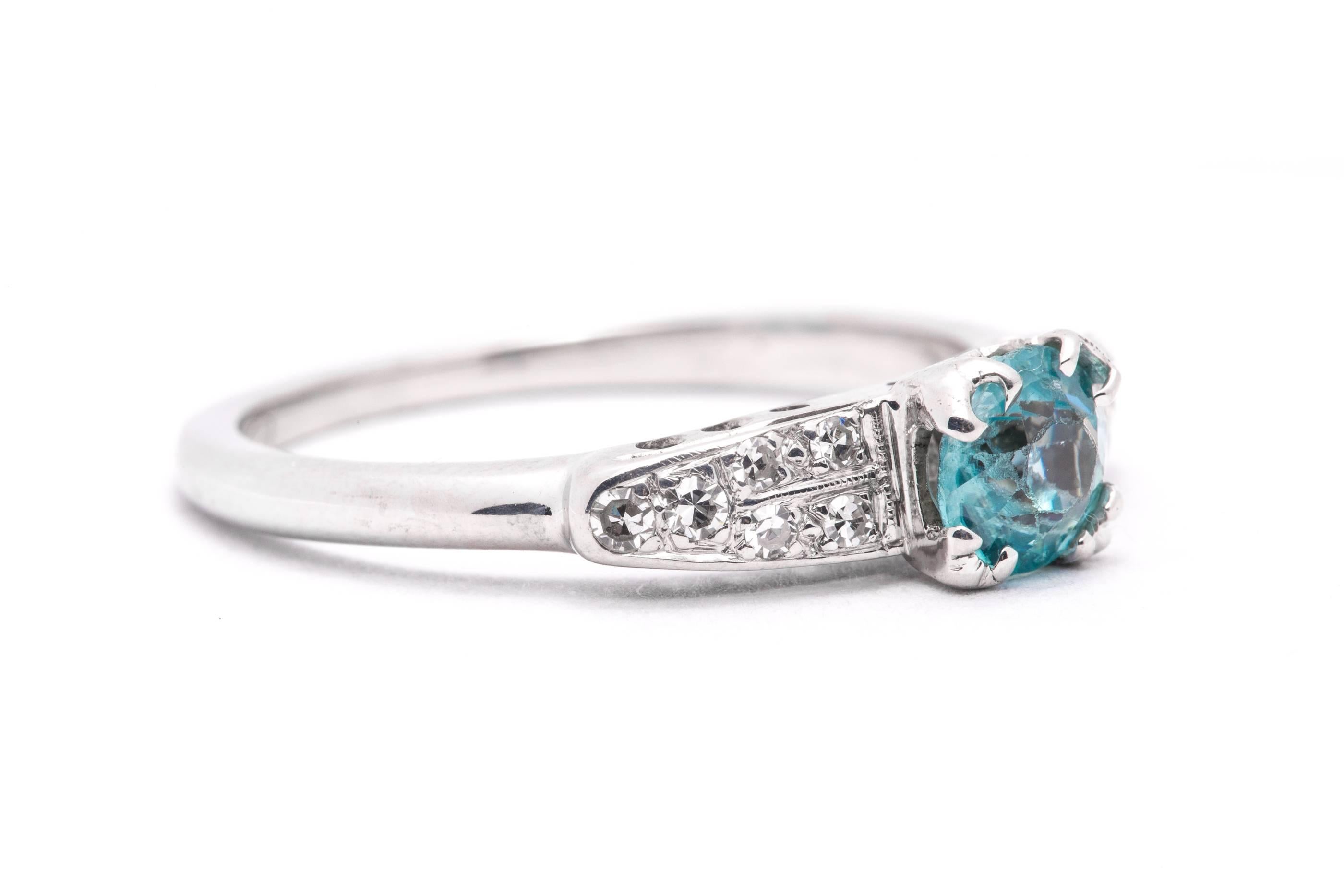 An art deco period blue zircon and diamond ring in 18 karat white gold.  Centered by a one carat European cut blue zircon, this ring features accenting pave set Swiss cut diamonds.

Grading as beautiful vivid sky blue color, the blue zircon is of VS