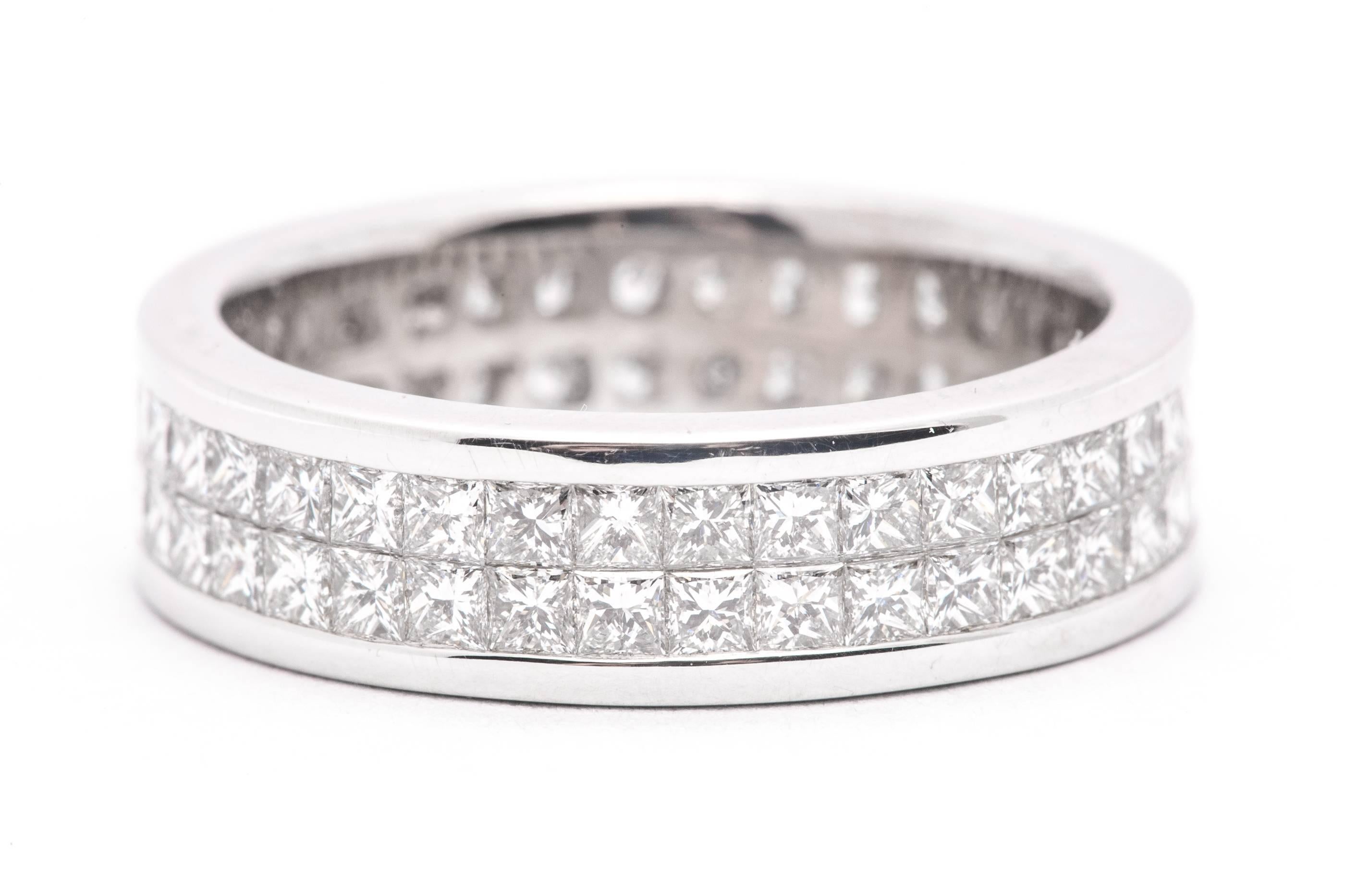 A platinum, and princess cut diamond eternity band.  Set with a double row of invisible set diamonds this band features a total of seventy two diamonds weighing a combined 3.60 carats.

Grading as VS clarity and G color, the superbly matched
