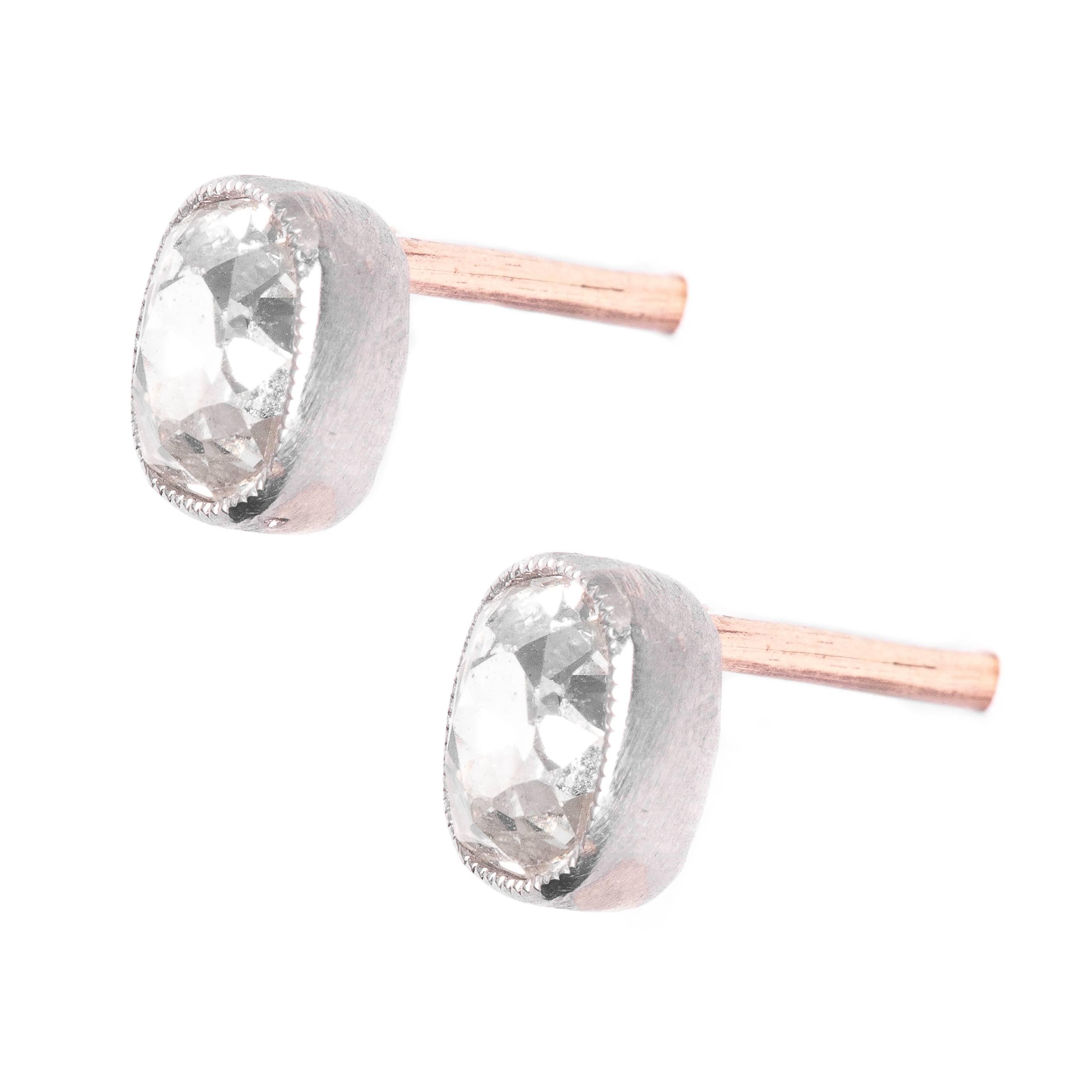 A beautiful pair of  diamond stud earrings in platinum.  Featuring a pair of perfectly matched antique mine cut cushion shaped diamonds, these earrings boast hand mille grained platinum bezel settings.

Grading as beautiful VS2 clarity and H color,