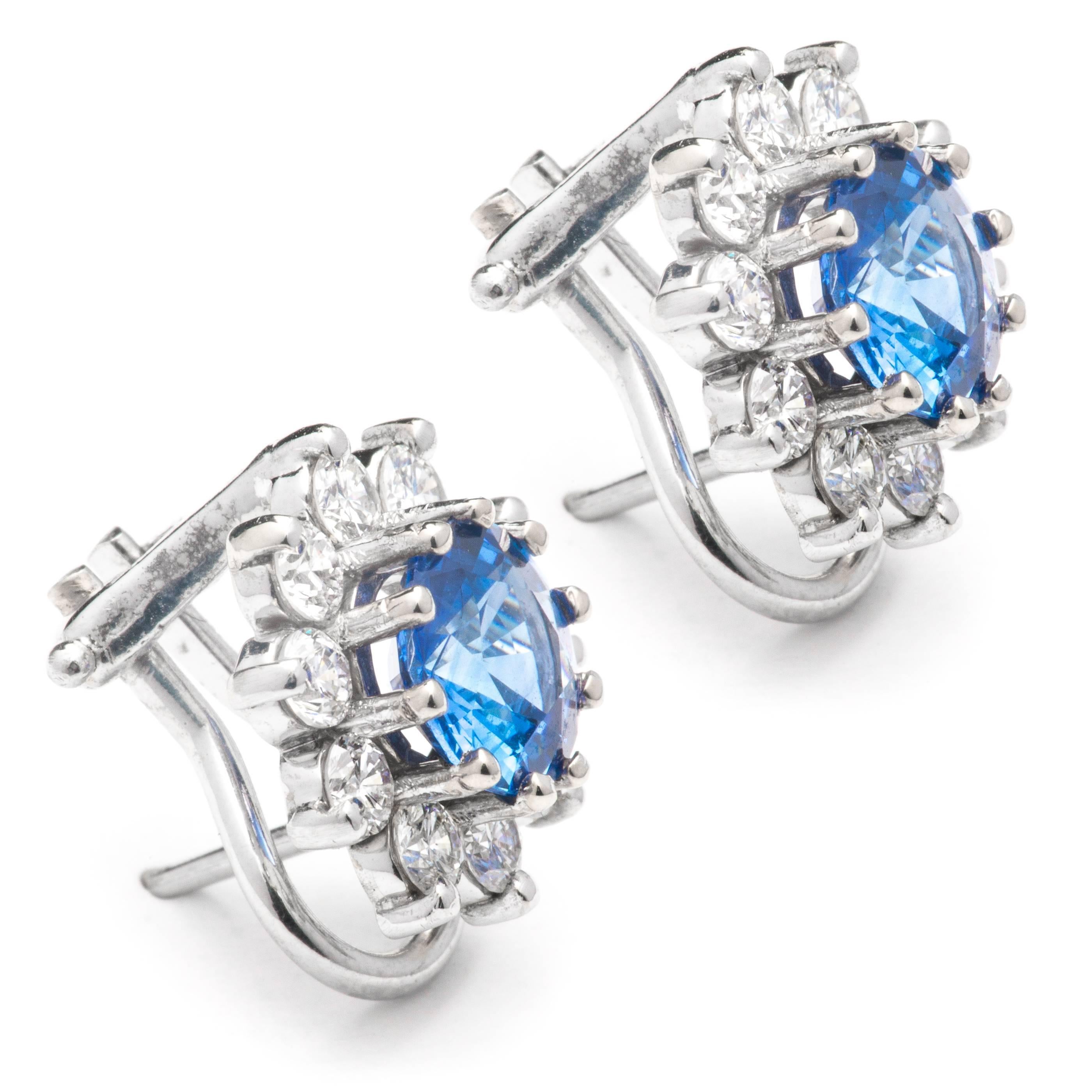 A pair of very fine quality sapphire, and diamond earrings in 18 karat white gold.  Centered by a pair of perfectly matched exceptionally fine quality sapphires these earrings feature a halo of high quality brilliant cut diamonds.

Of exceptionally