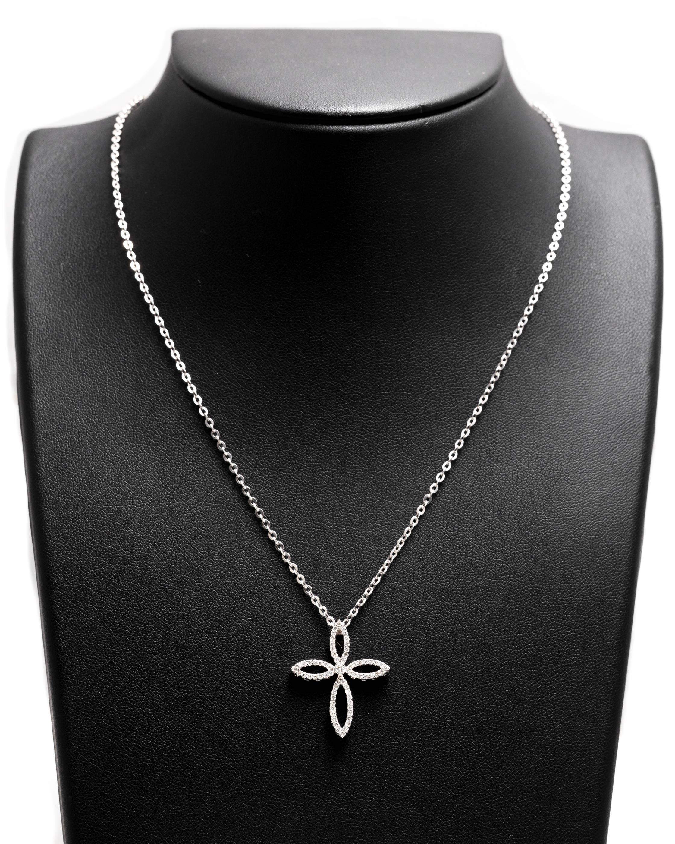 A sparkling pave set diamond cross pendant in 14 karat white gold.  Featuring a total of 67 diamonds weighing a combined 0.36 carats, this diamond features a unique and organic open design.

Grading as VS clarity and G color, the high quality