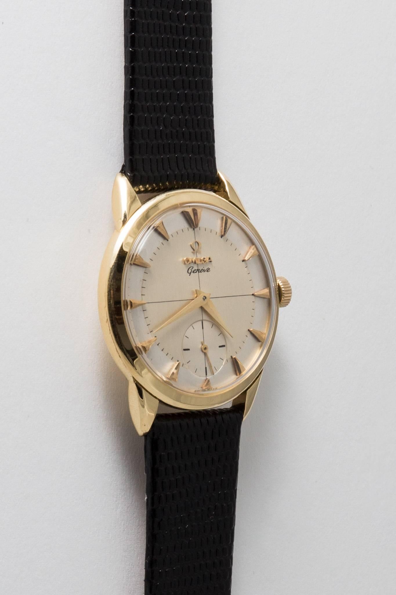 A vintage mens Omega wrist watch in solid 18 karat yellow gold. Coming from their higher end line, the Geneve collection this watch features a heavy 18 karat gold case and a silvered dial with yellow gold dagger shaped hour markers.

In excellent