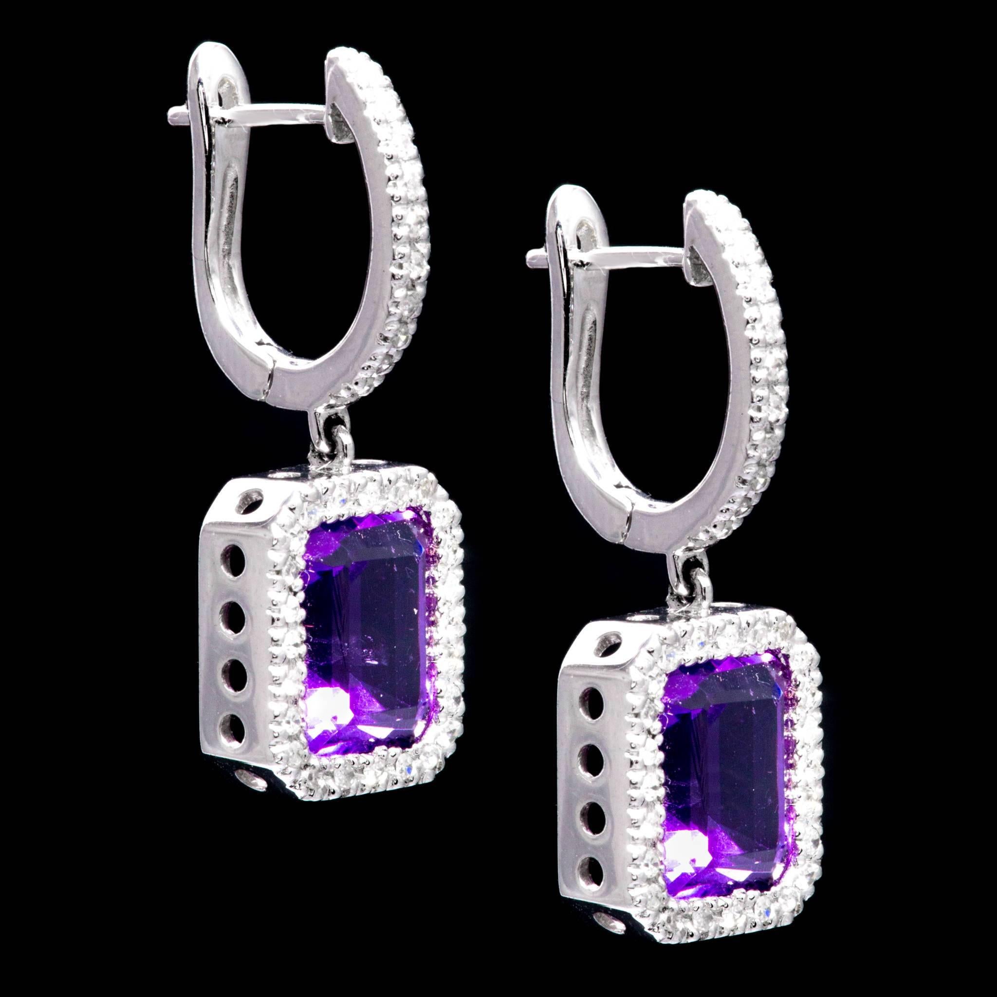 Beacon Hill Jewelers Presents:

A beautiful pair of dangling amethyst, and diamond earrings in 14 karat white gold. Each earring is centered by a 2 carat rich vivid purple amethyst framed by sparkling pave set diamonds.

Grading as VVS clarity the