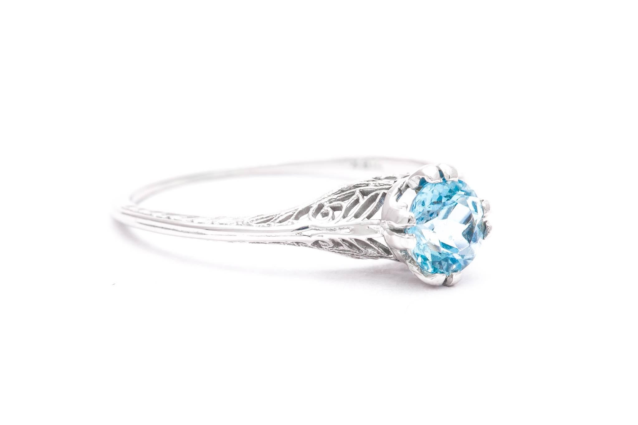 An art deco period aquamarine solitaire filigree ring in 18 karat white gold.  IN excellent condition, this hand crafted art deco period ring features a 0.75 carat European cut aquamarine set in a beautiful filigree mounting.

Grading as beautiful