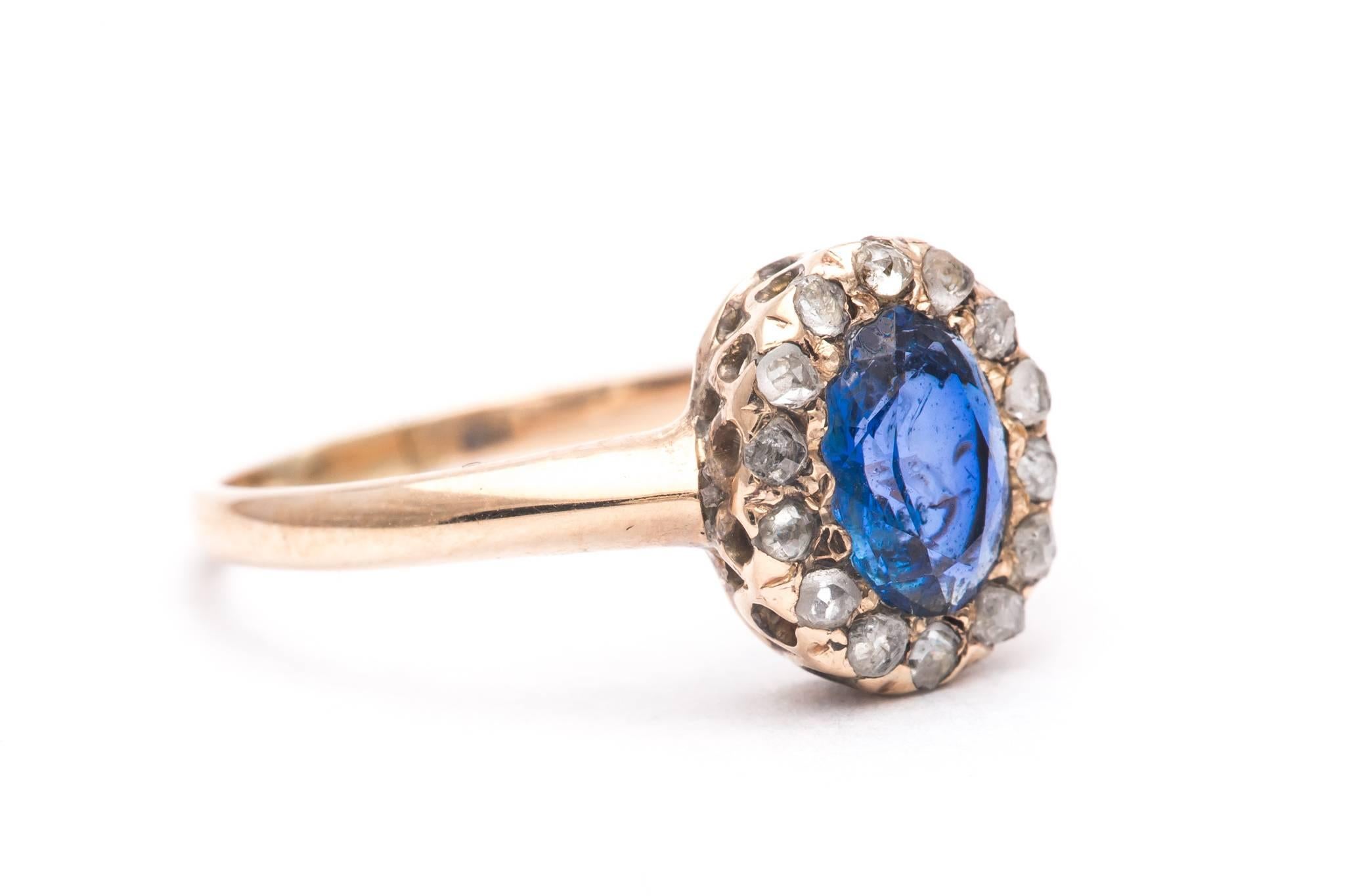 A beautiful original early victorian period sapphire, and diamond ring in yellow gold.  Centered by a 1.14 carat antique oval cut sapphire, this ring features a halo of early rose cut diamonds surrounding the center sapphire.

Of beautiful rich