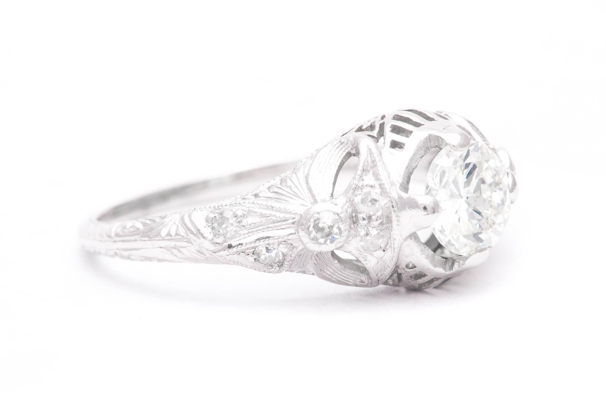A fantastic original art deco period diamond engagement ring in luxurious platinum.  Centered by a 0.62 carat antique European cut diamond, this ring features a unique bow like design along with pave set accenting diamonds.

All grading as beautiful