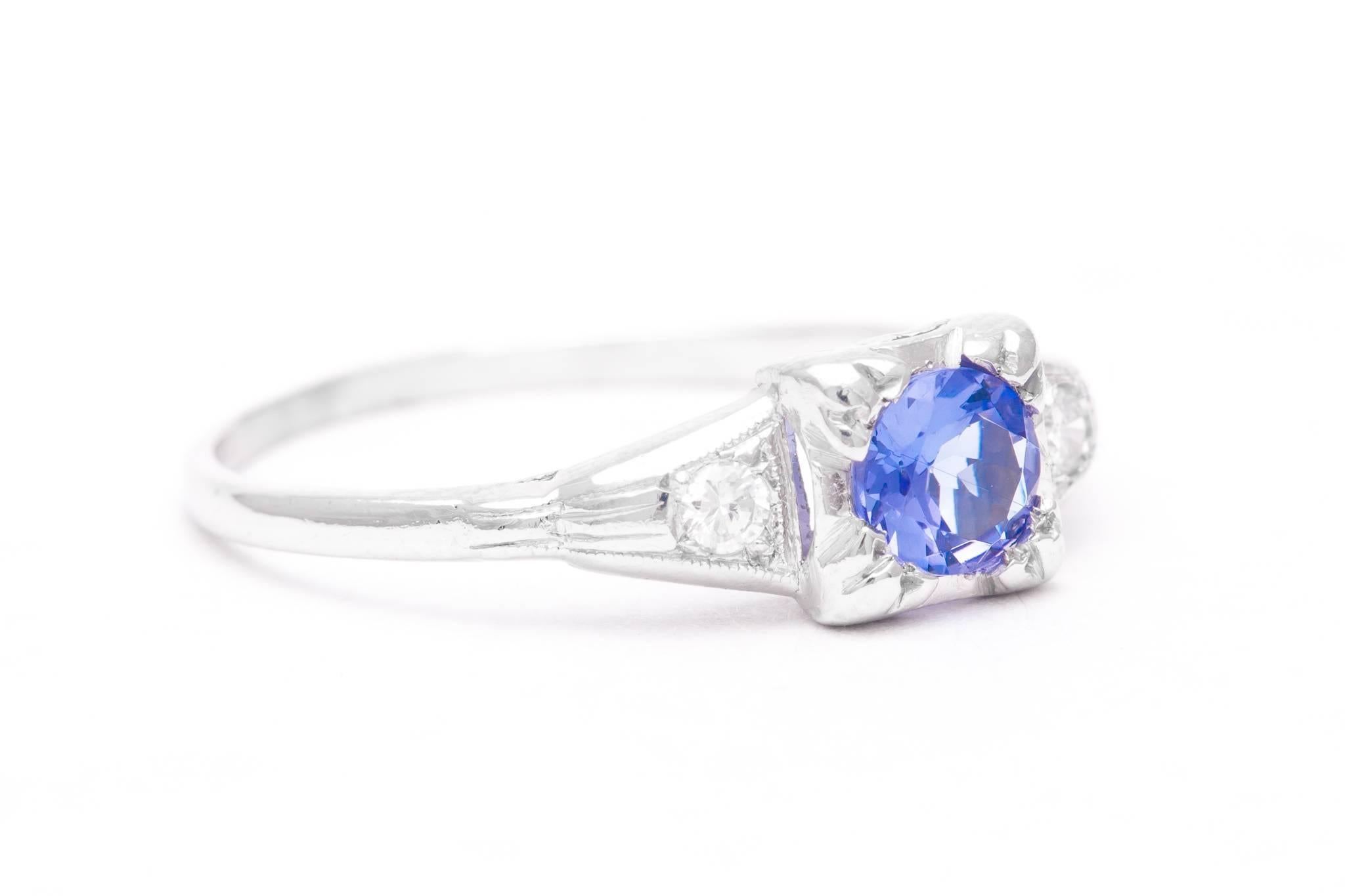 A beautiful art deco period sapphire, and diamond three stone ring in luxurious platinum.  Centered by a 0.50 carat European cut sapphire this ring also features a pair of accenting 0.08 carat total weight European cut diamonds.

Grading as VS