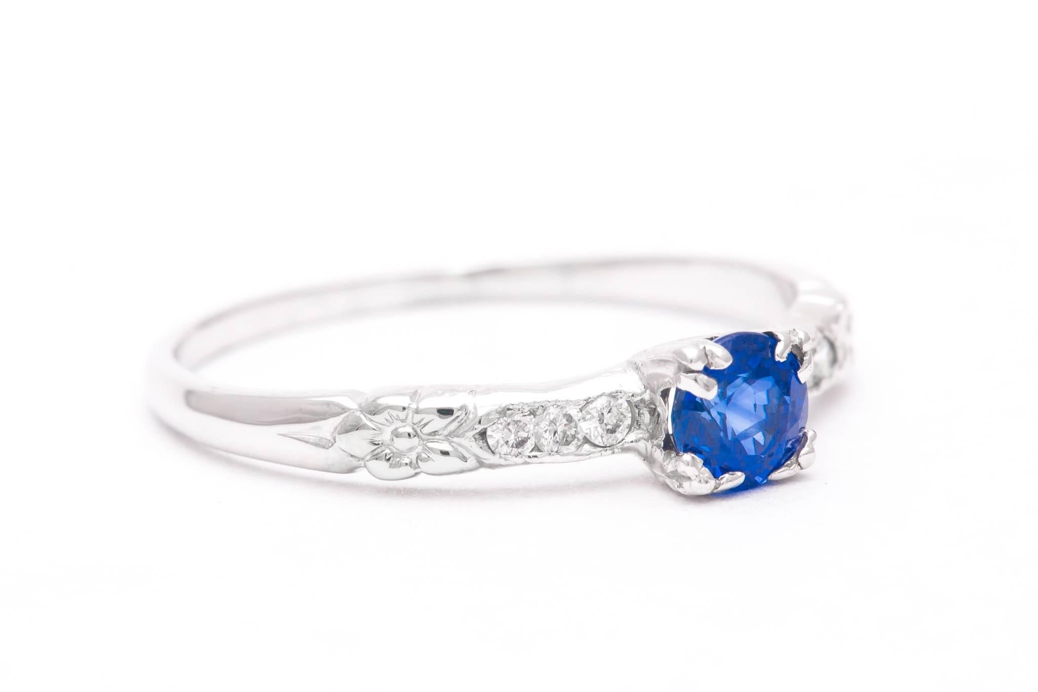 An original art deco period orange blossom pattern sapphire and diamond ring in luxurious platinum.  Centered by a rich vivid blue sapphire this ring features accenting diamonds and hand carved orange blossom flowers.

Once the most popular design