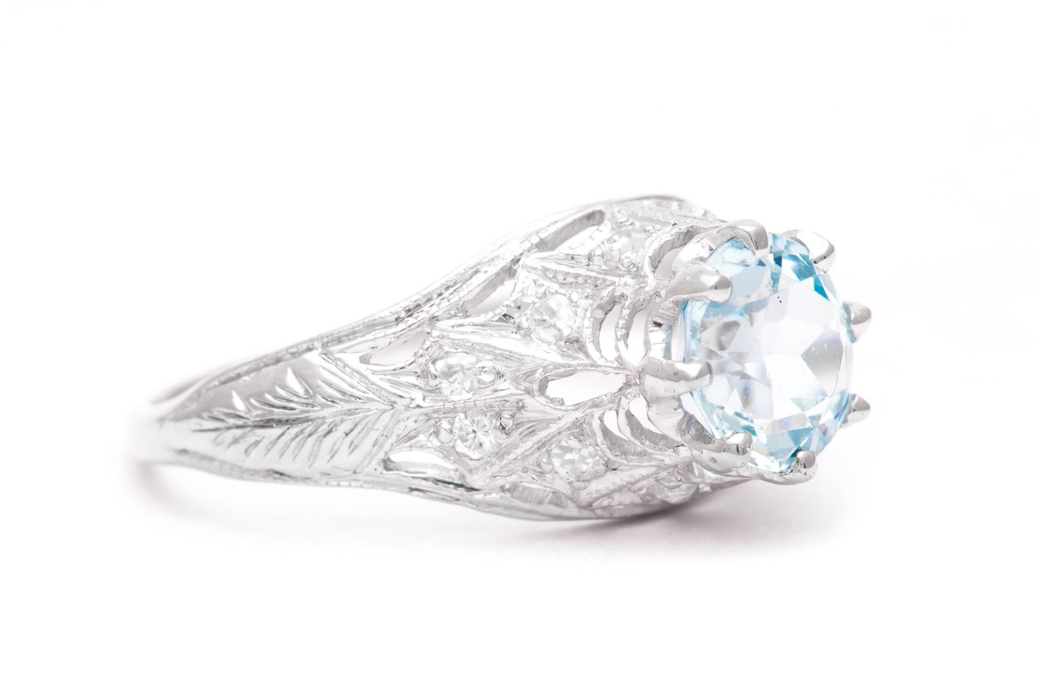 A beautiful hand crafted art deco period aquamarine and diamond ring in luxurious platinum.  Centered by a sparkling antique European cut aquamarine weighing 1 carat, this ring features pave set accenting diamonds throughout the mounting.

Set