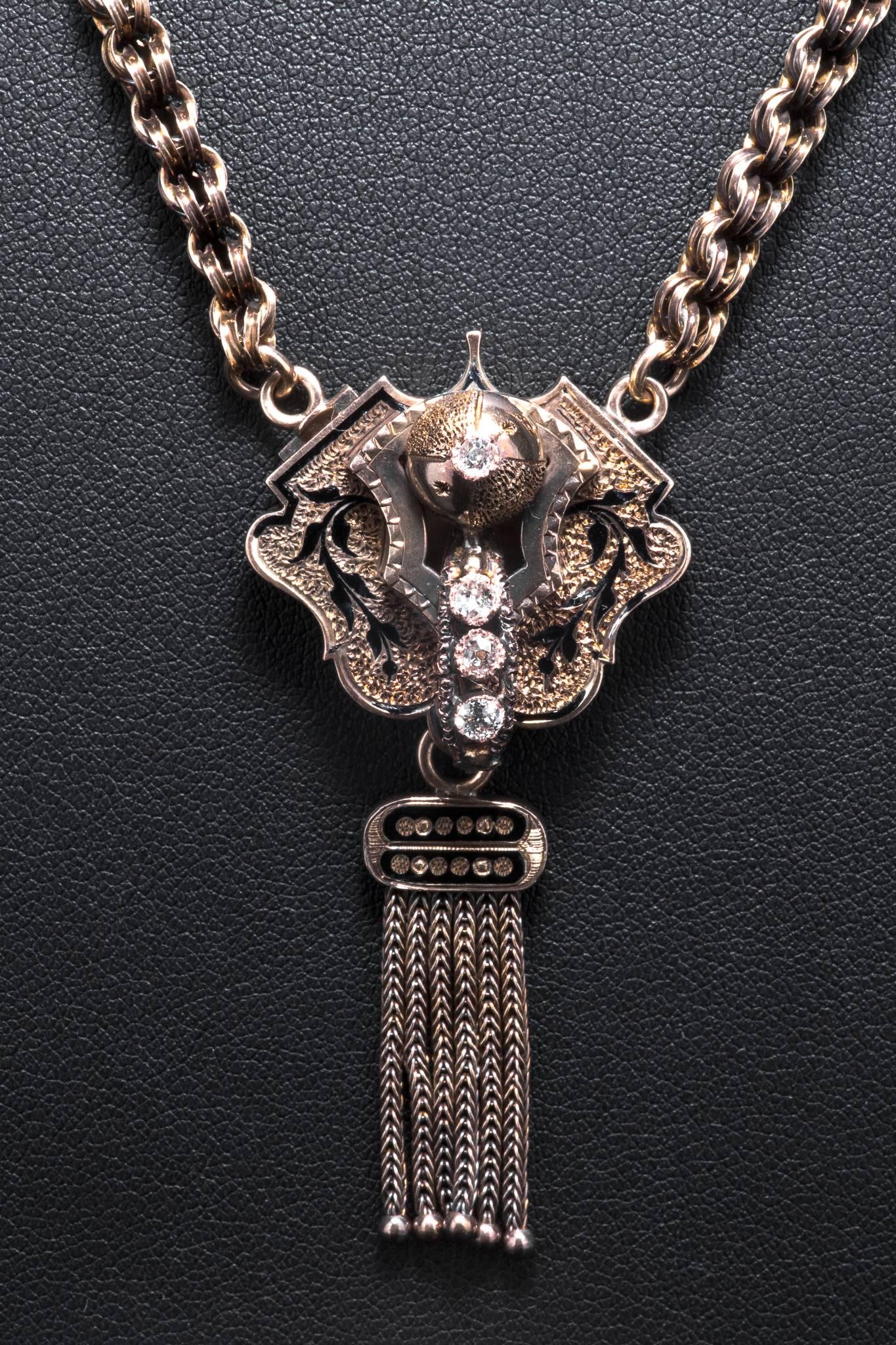 Presenting an original victorian period enamel and diamond tassel necklace in yellow gold.  Featuring rich black floral enameling and four antique mine cut diamonds this necklace also features a unique hand crafted link chain.

In excellent
