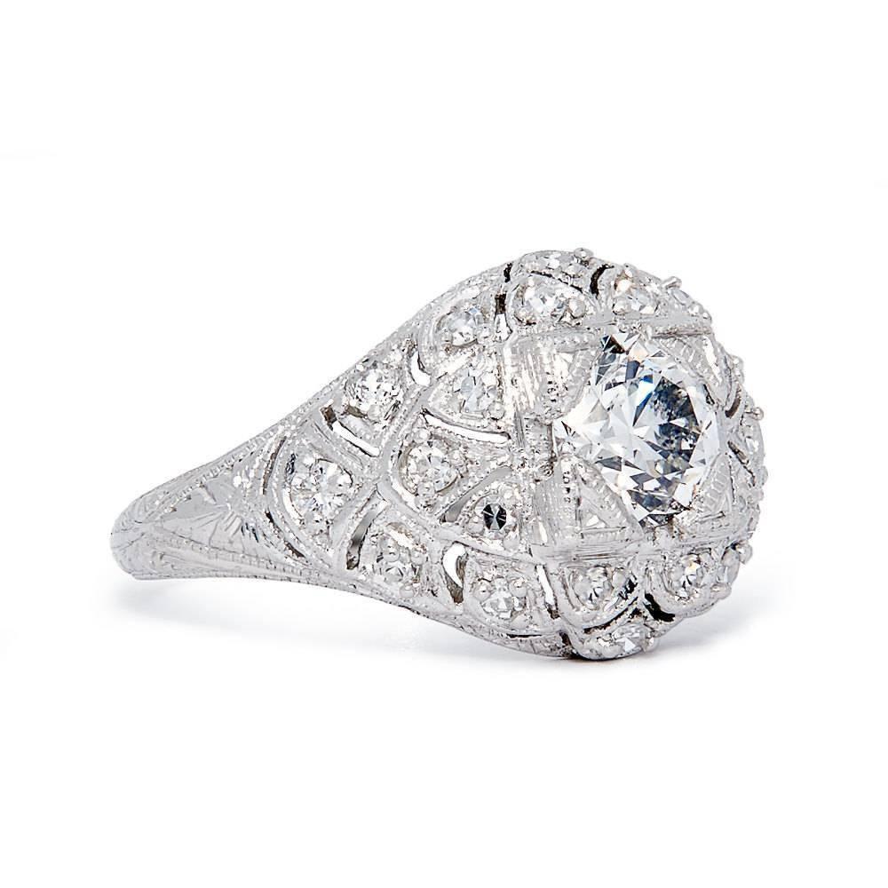 A stunning and truly unique original Edwardian period diamond engagement ring in luxurious Platinum. Designed similar to the feathers of a bird, this ring features a plethora of sparkling old European cut diamonds surrounding a central 0.76 carat