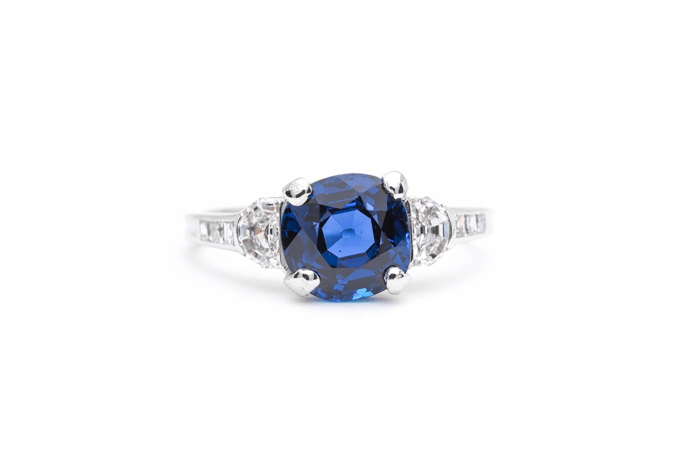 Beacon Hill Jewelers Presents:

A stunning art deco period sapphire and diamond engagement ring by Tiffany & Company. Centered by a gorgeous 2.23 carat cushion shaped vivid blue sapphire of truly exceptional quality, this ring features half