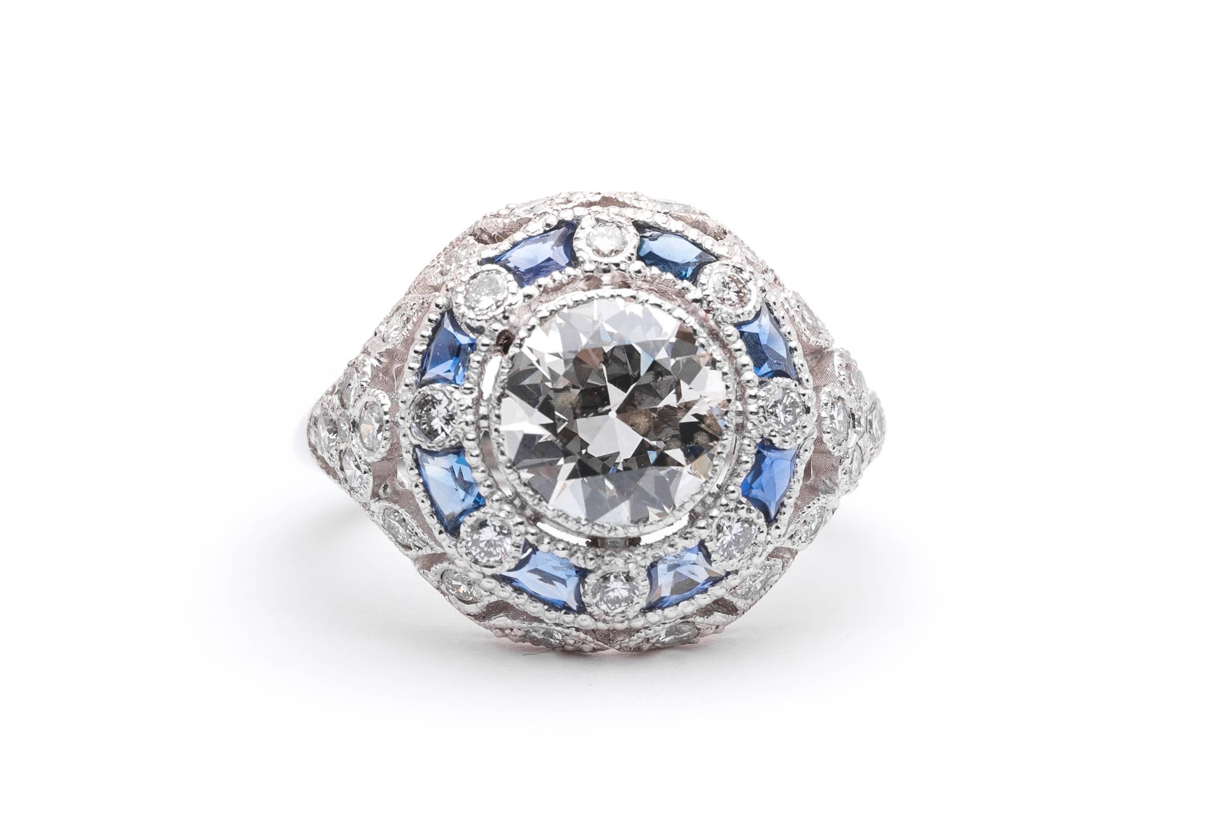 Beacon Hill Jewelers Presents:

A truly enchanting Edwardian style floral motif 3.12 carat diamond, and sapphire engagement ring in platinum. Centering this stunning ring is a substantial EGL certified 1.60 carat antique European cut diamond