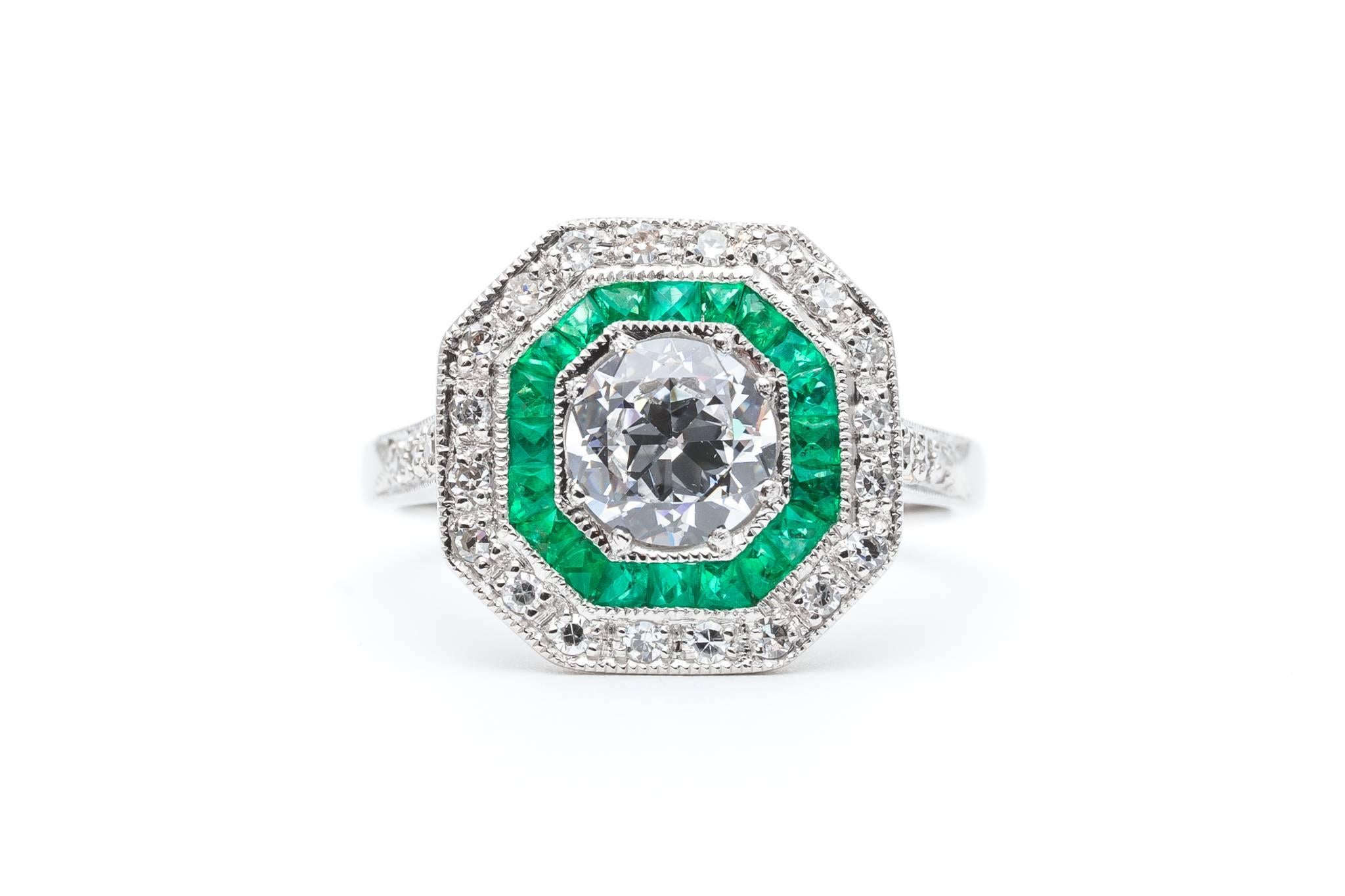 An exceptionally beautiful emerald and diamond ring in luxurious platinum. Featuring beautiful French cut Colombian emeralds, sparkling single cut and antique mine cut diamonds, and hand applied mille grain beading, this ring is a truly stunning