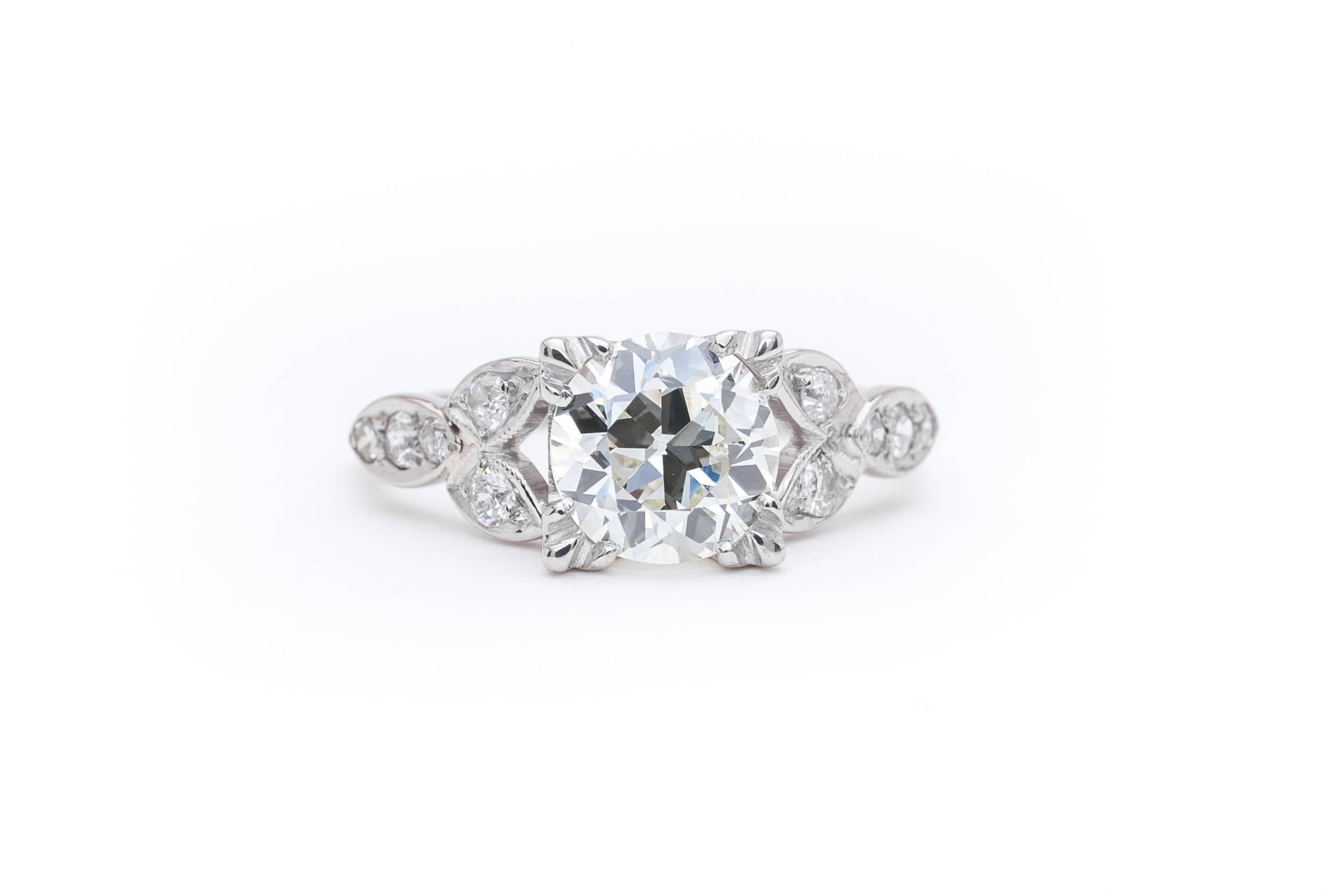 A beautiful vintage diamond engagement ring in luxurious platinum. Centered by a 1.31 carat claw set GIA Certified European cut diamond this ring features hand wrought platinum leaves framing the glistening diamond.

Grading as beautiful VS1