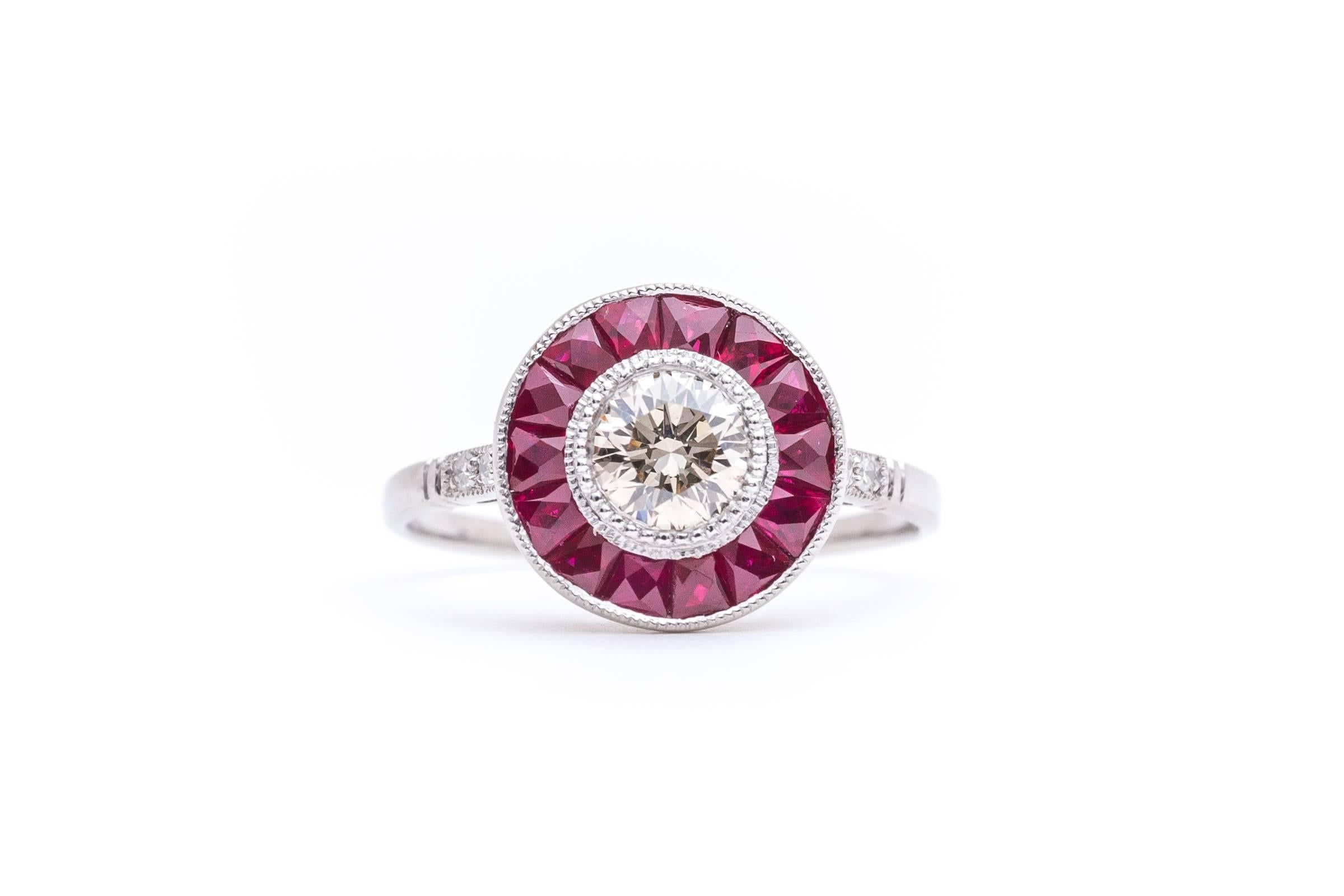 A stunning champagne diamond and ruby target ring in luxurious platinum. Completely hand crafted, this stunning target ring is a prime example of a French style engagement ring. Centered by a natural fancy champagne diamond surrounded by vivid red