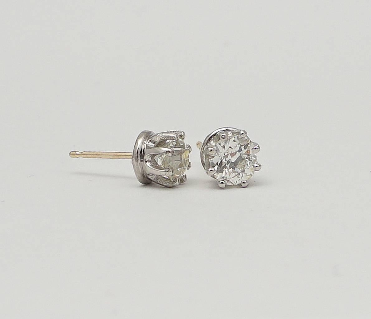 A pair of beautiful diamond stud earrings in luxurious platinum. Centered by a pair of beautifully matched antique old European cut diamonds, these earrings feature traditional Tiffany style mountings handcrafted in platinum.

Grading as beautiful