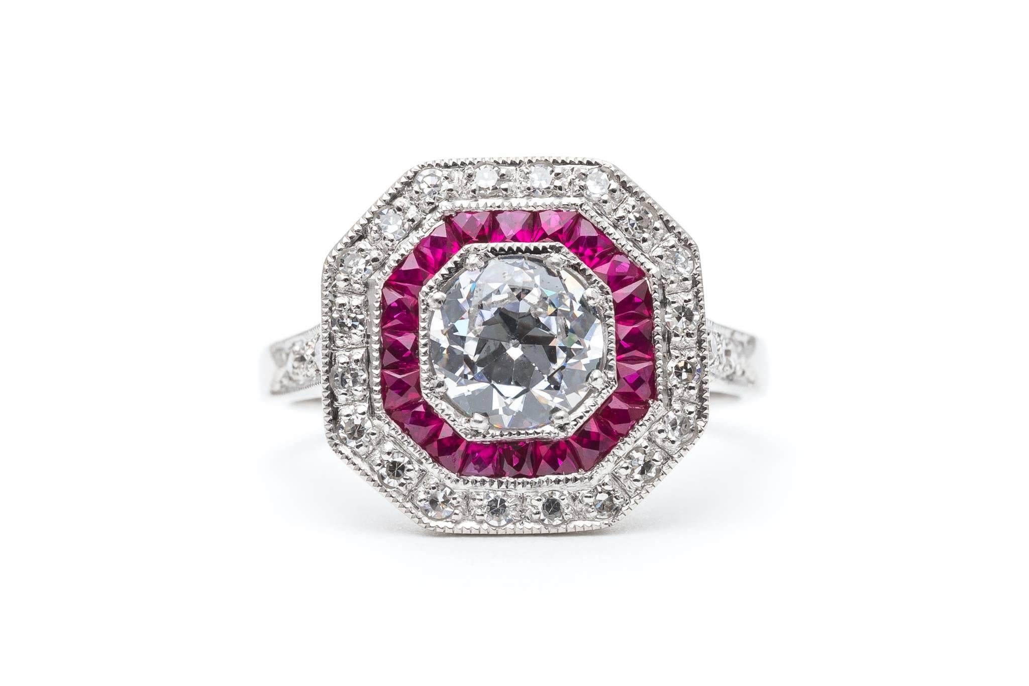 An exceptionally beautiful ruby and diamond ring in luxurious platinum. Featuring beautiful French cut rubies, sparkling single cut and antique mine cut diamonds, and hand applied mille grain beading, this ring is a truly stunning engagement