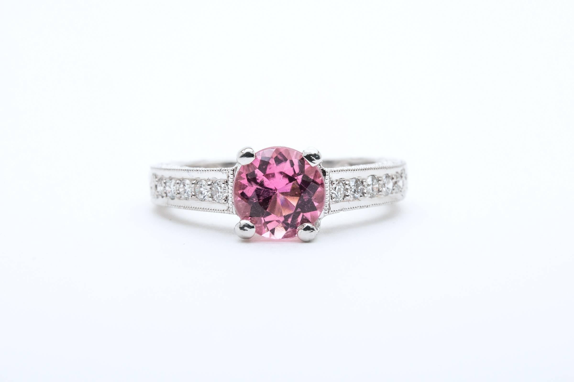 Beacon Hill Jewelers Presents:

A beautiful vintage pink tourmaline and diamond ring in luxurious platinum. Centered by a gorgeous 1.20 carat pink tourmaline of the finest quality, this ring features beautiful hand engraving and hand pierced hearts