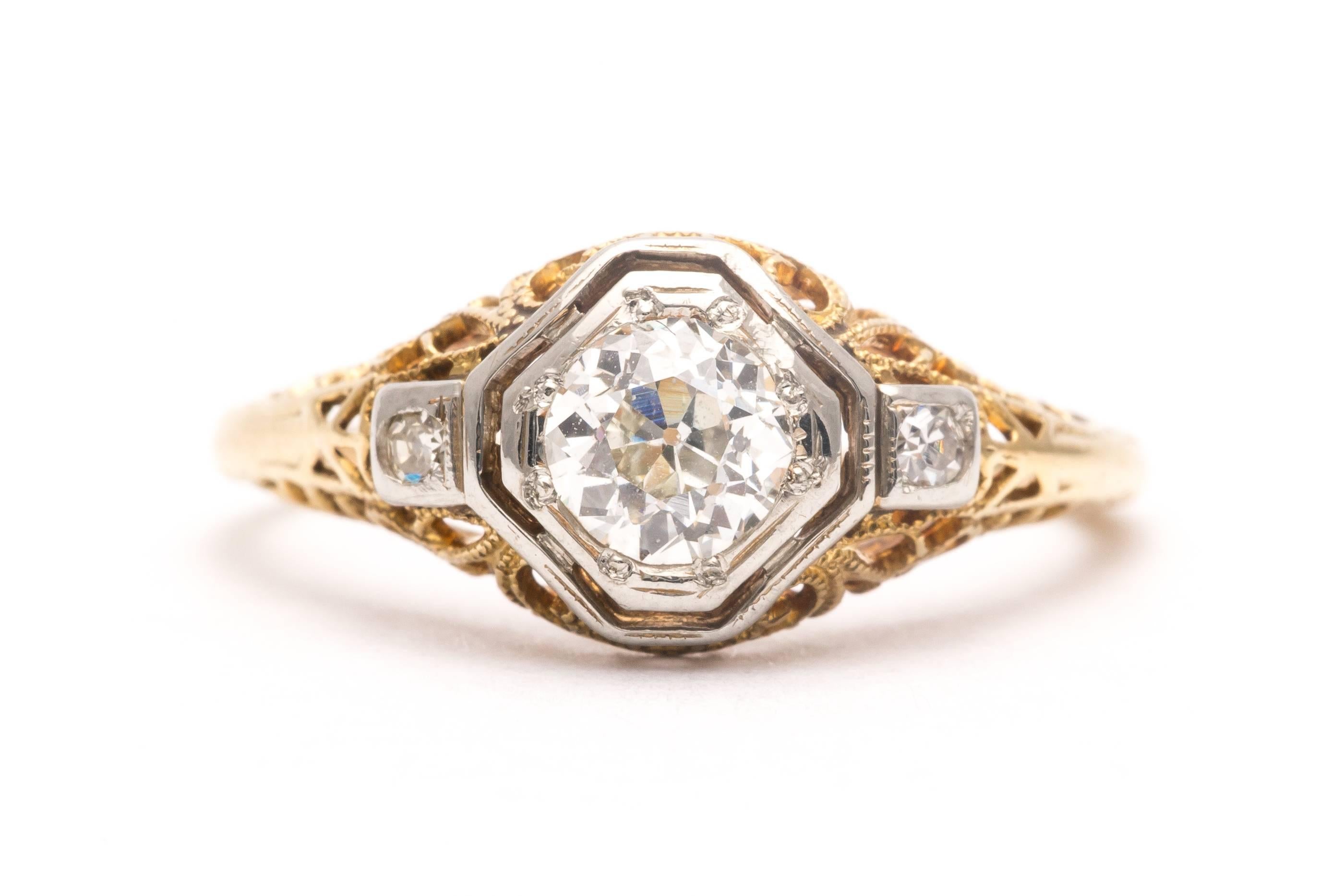 Beacon Hill Jewelers Presents:

A beautiful original Edwardian period diamond engagement ring in platinum and 14 karat yellow gold. Centered by an old European cut diamond this ring features a platinum mount to secure the three diamonds, along