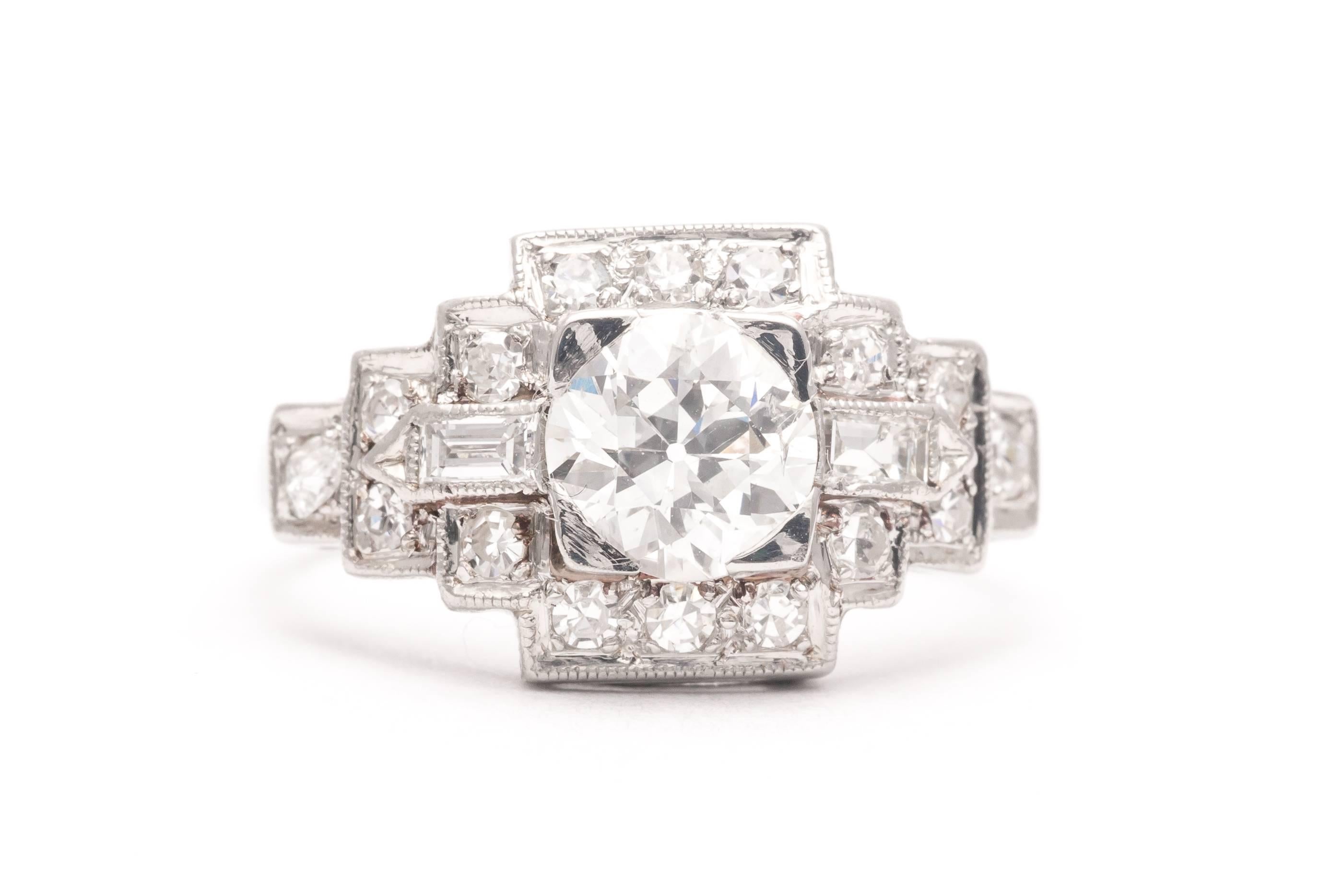A classic art deco diamond engagement ring in luxurious platinum. Centered by a 0.85 carat old European cut diamond, this ring features a classic stepped design set throughout with accenting European and baguette cut diamonds in a handmade platinum