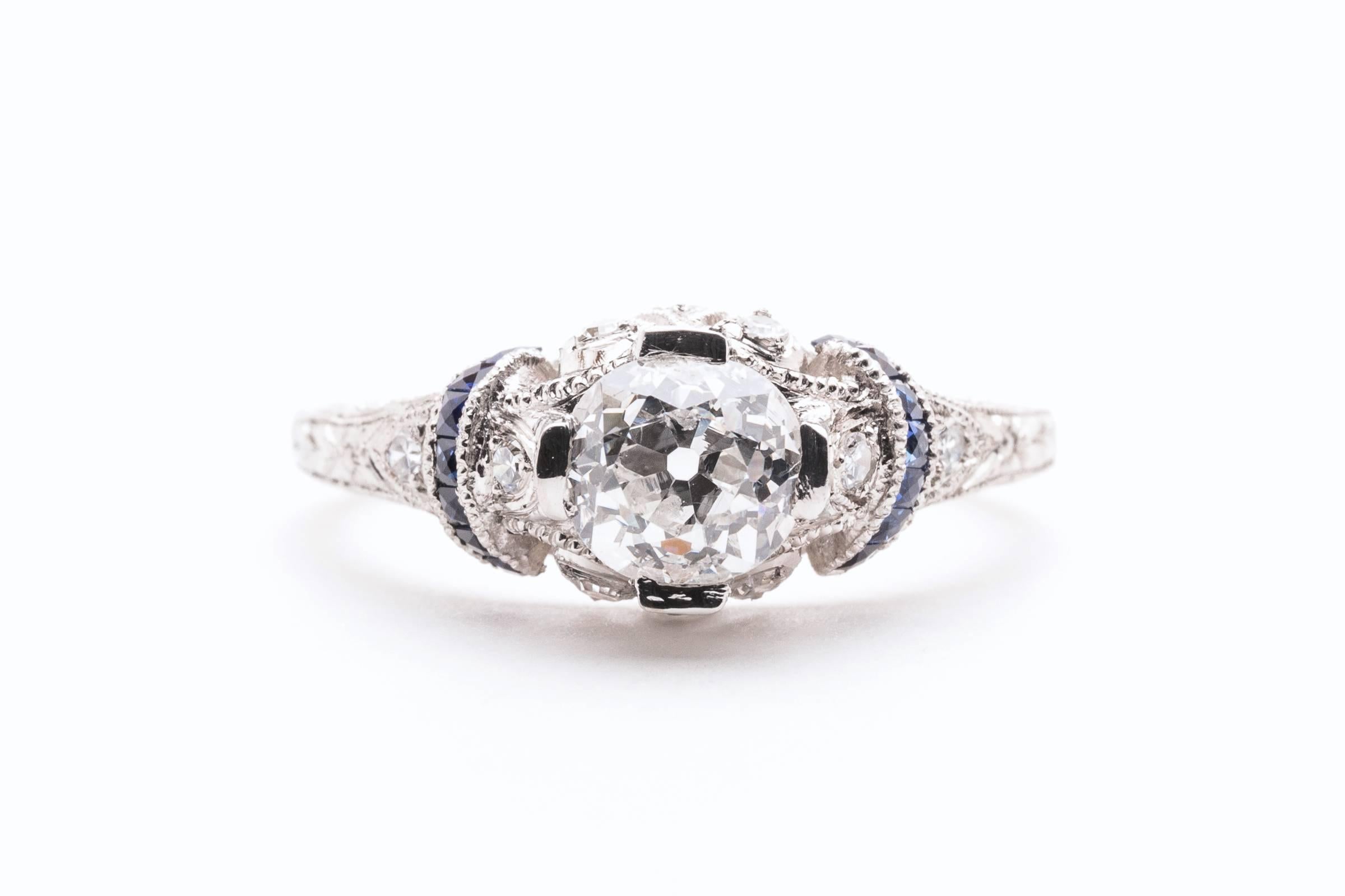 
Beacon Hill Jewelers Presents:

A beautiful art deco period hand crafted diamond engagement ring in luxurious platinum. Centered by a sparkling old mine cut diamond, this ring features fantastic hand engraving throughout complemented by hand