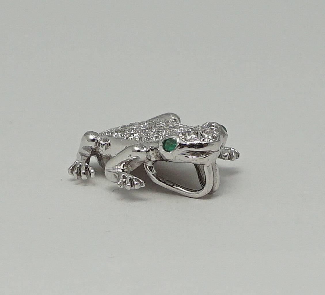 Beacon Hill Jewelers Presents:

A diamond studded frog pendant with forest green emerald eyes. Set with a total of twenty seven round brilliant cut diamonds, this one of a kind handcrafted platinum pendant is of truly exceptional