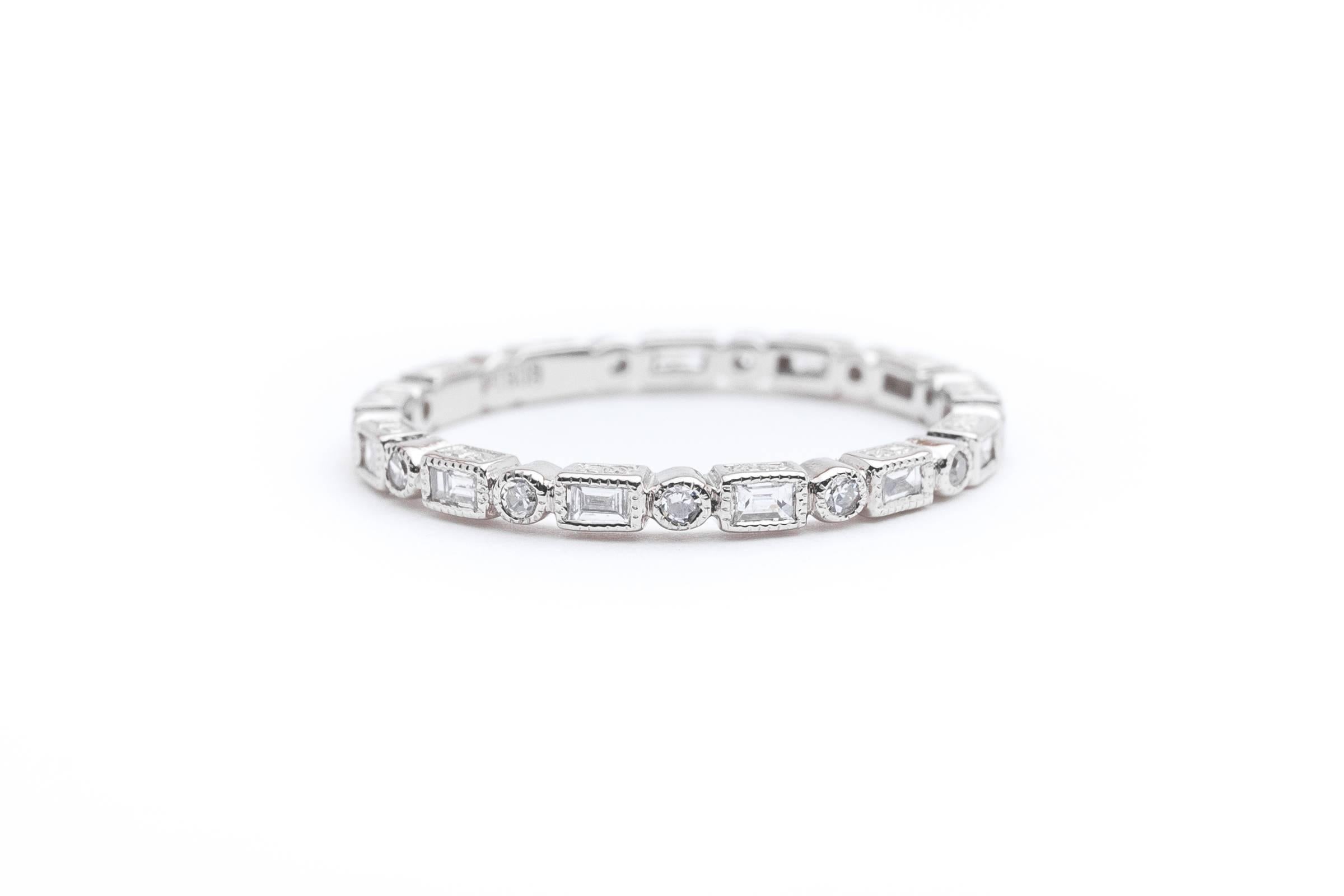 Beacon Hill Jewelers Presents:

A beautiful platinum baguette, and round diamond eternity band. Set with thirteen baguette, and thirteen round diamonds, this beautiful eternity band also features hand engraving work on the sides.

Weighing a
