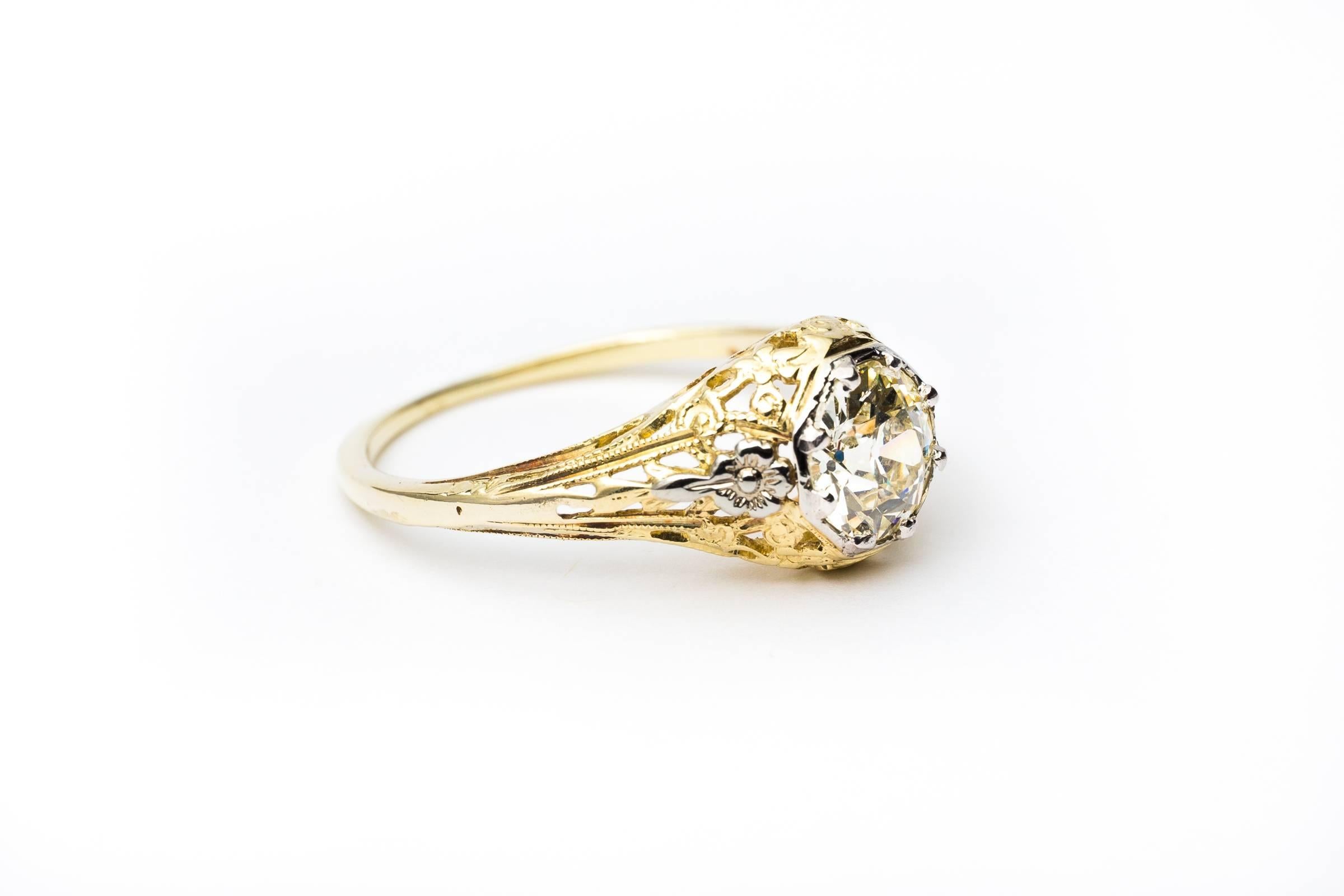 Beacon Hill Jewelers Presents:

A beautiful edwardian period diamond solitaire engagement ring in luxurious platinum & 18 karat yellow gold. Boasting hand carved platinum flowers and a platinum head securing the sparkling diamond this ring