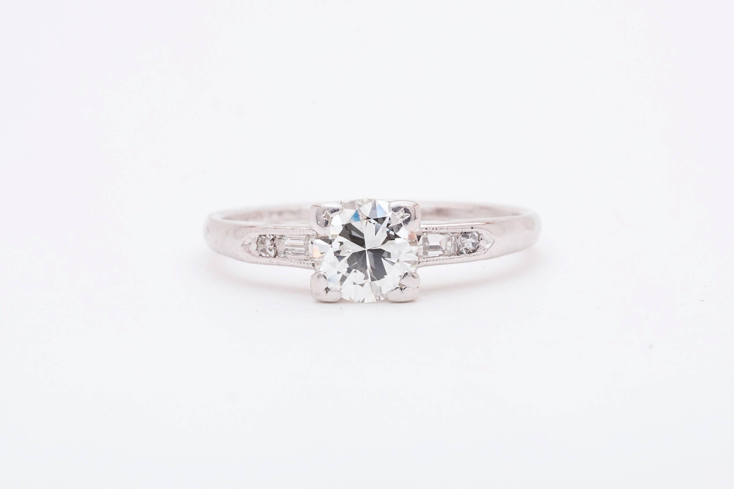 Beacon Hill Jewelers Presents:

A classic original art deco period diamond engagement ring in platinum. Centered by a sparkling old European cut diamond this ring features a pair of baguette and round accenting diamonds in a classic art deco