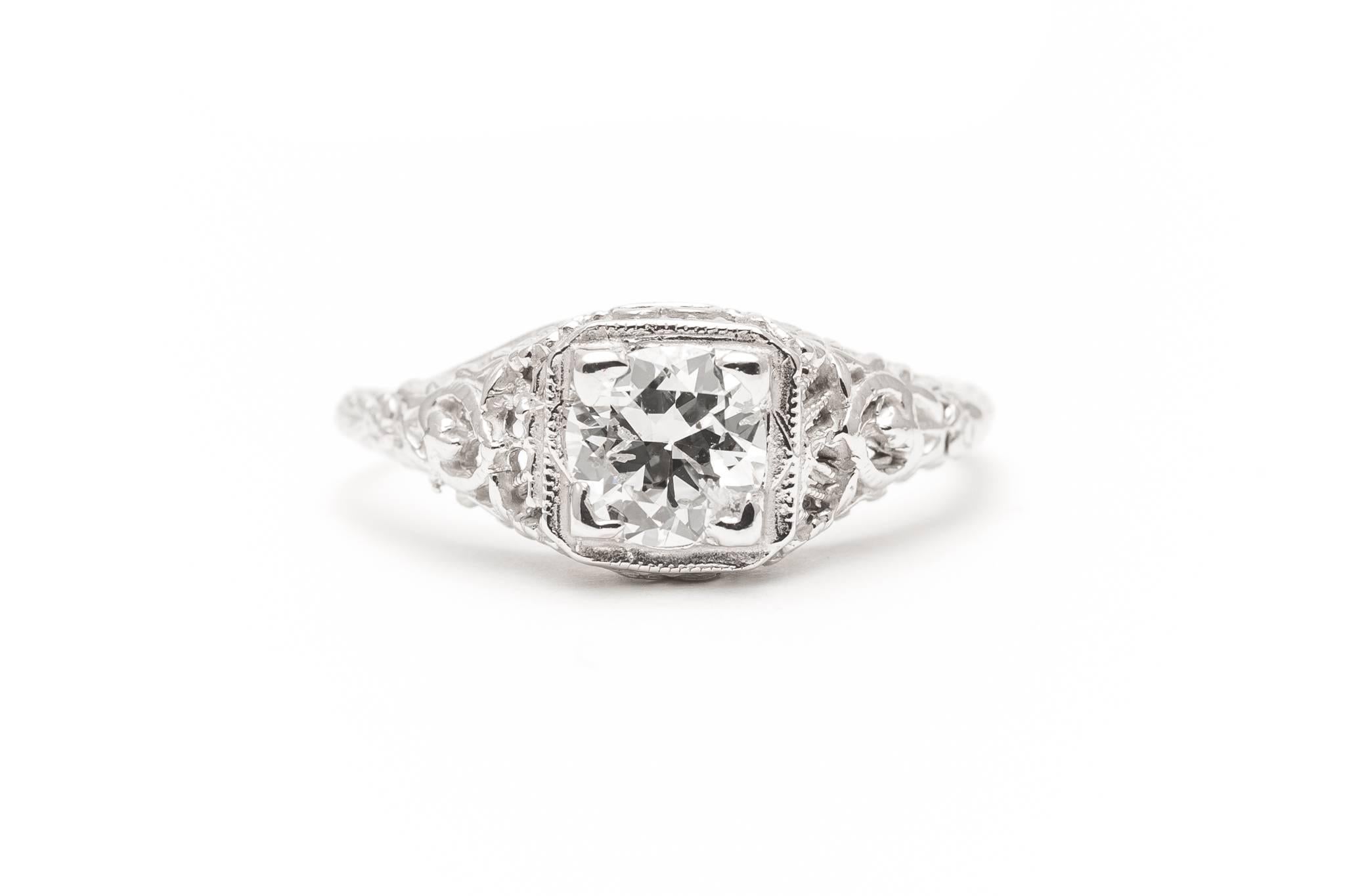 Beacon Hill Jewelers Presents:

A beautiful original art deco period diamond engagement ring in 18 karat white gold. Centered by a 0.65 carat old European cut diamond of ultra white E/F colorless color and beautiful SI clarity this ring features