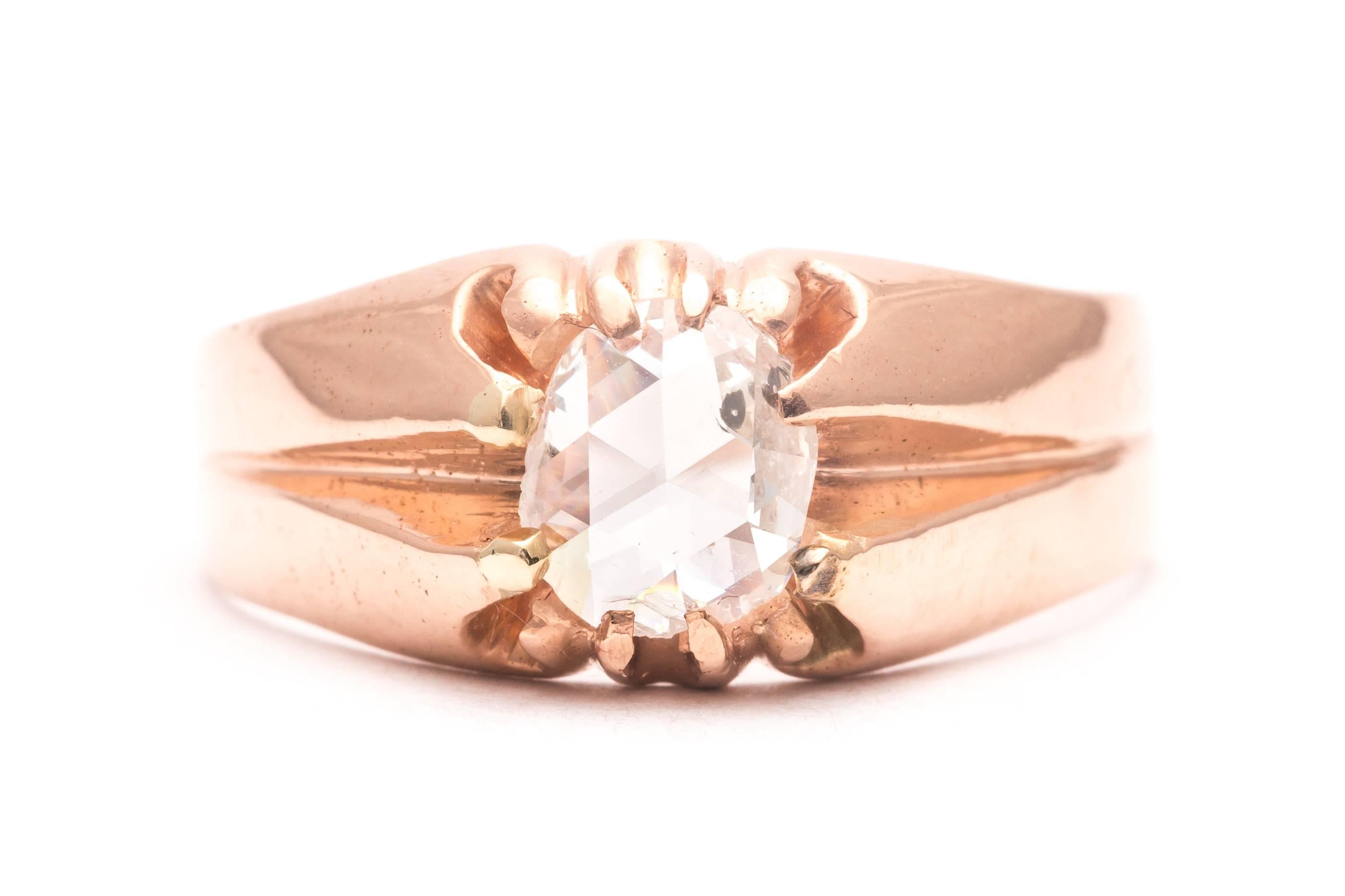 An antique victorian period rose cut diamond mens ring in 14 karat rose gold. Set with a single diamond in a beautifully style mounting, this ring is a prime example of a victorian era mens ring. Secured by beautifully stylized rose gold claw