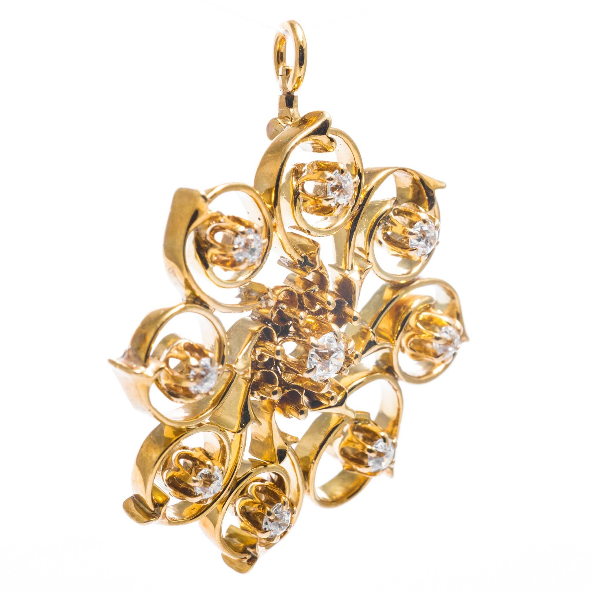 A beautiful swirl form diamond pendant necklace in 14 karat yellow gold.  Set with a total of nine high quality antique European cut diamonds this necklace has a truly entrancing and almost spinning appearance to it.

Centerin this necklace is a