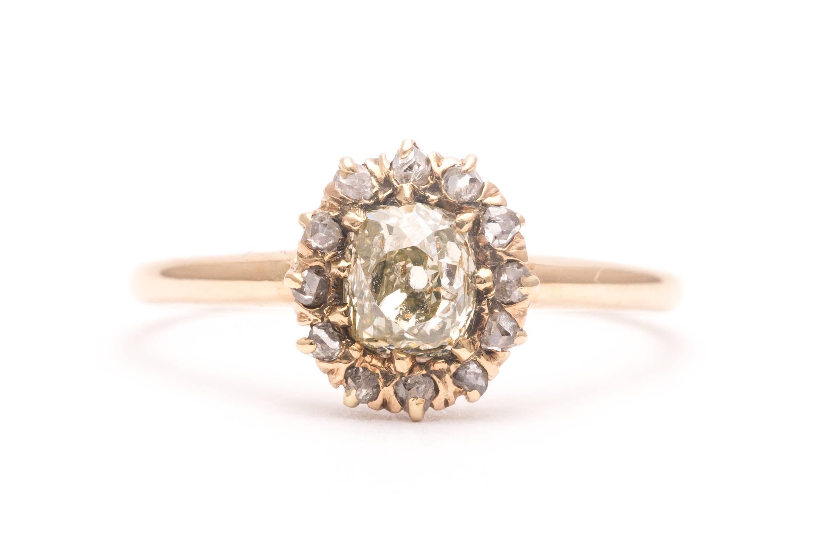 Beacon Hill Jewelers Presents:

An original antique georgian period diamond engagement ring in yellow gold.  Centered by a cushion shaped mine cut diamond, this ring boasts a halo of twelve rose cut diamonds encircling the center diamond.

Weighing