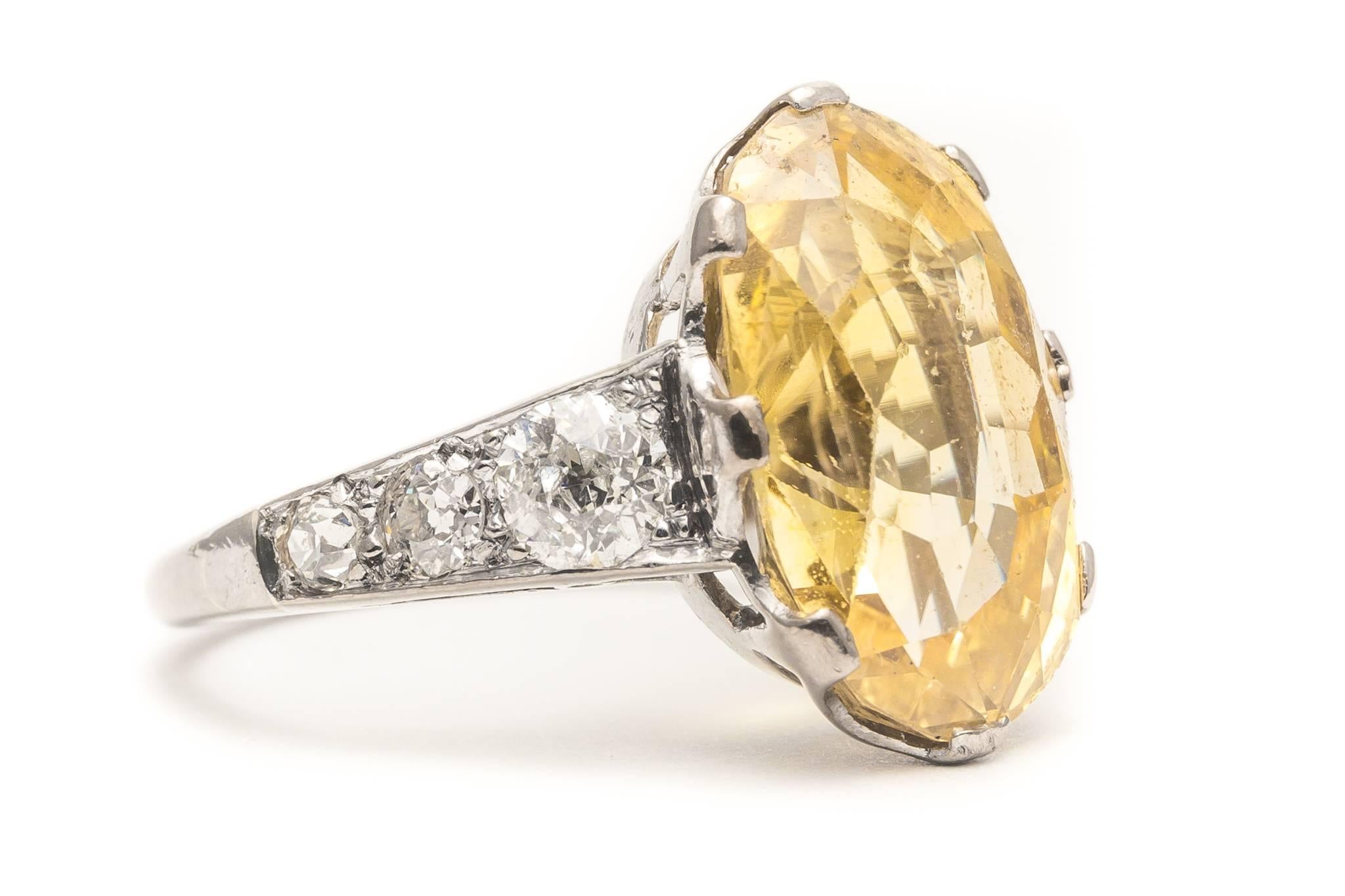 Beacon Hill Jewelers Presents:

A beautiful original edwardian period yellow sapphire and diamond ring in platinum.  Of beautiful rich vivid lemon yellow color, the high quality antique cut yellow sapphire sits framed by a total of six high quality