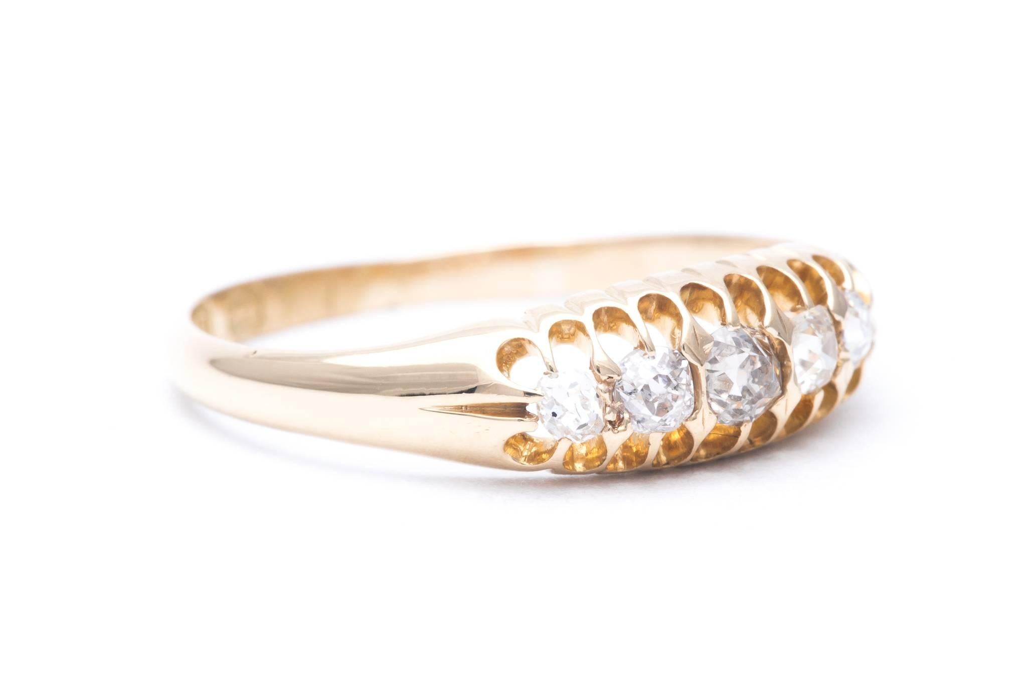 An English made edwardian period diamond wedding band in 18 karat yellow gold.  Hallmarked for Birmingham England, this band features five graduated antique mine cut diamonds weighing a combined 0.33 carats.

In excellent condition, this ring is