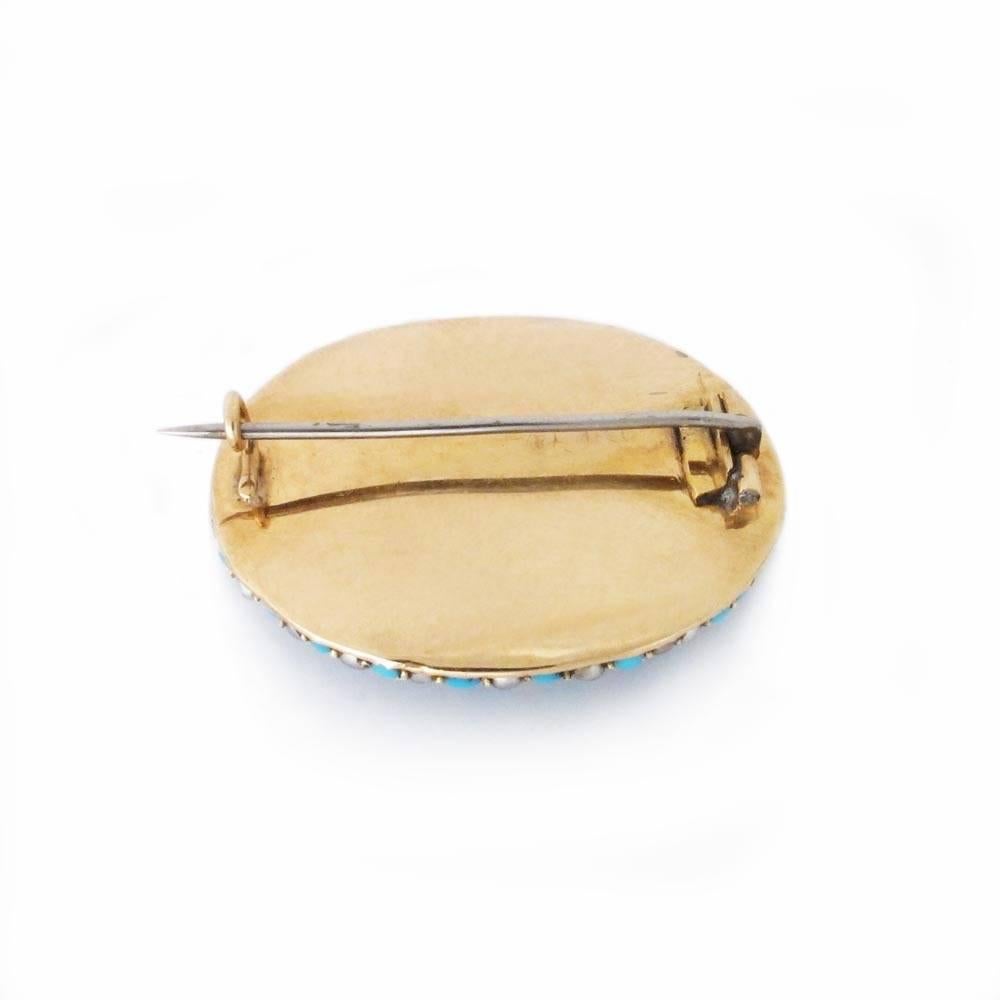 A strikingly modern design, beautifully set.

14K gold, of low domed oval form set with lines of seed pearls and turquoise cabochons, marked on fitting.