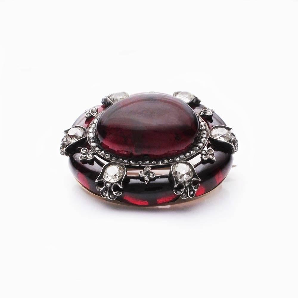 The central garnet about as wide as a ping-pong ball. Set in 15K gold alongside garnets and diamonds. In a fitted box from Robert Stewart of 75 Sauchiehell Street in Glasgow.

The Robert Stewart name was originally established by two brothers in