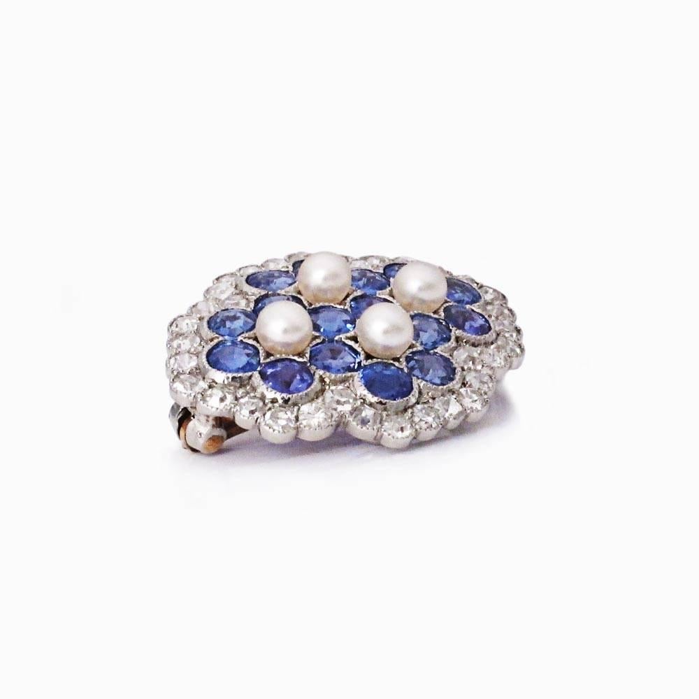 A very pretty little brooch, with Montana sapphires (about 1.7ct total), diamonds (about 0.65ct total), and pearls set in platinum.