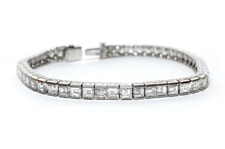 CIRCA: Art Deco 

STONES: Carre Cut Diamonds

DIAMONDS: 10.00ct

DIAMONDS: F-VS1

METAL: Platinum 

STYLE: Art Deco Line Tennis Bracelet.

ENGARVING: HAND ENRAVED

BRACELET WIDTH: 4.35MM

LENGTH: 6.85