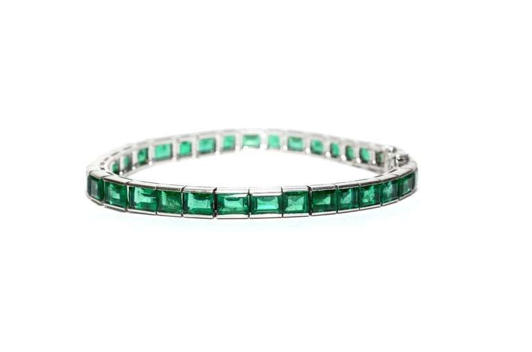 CIRCA: Art Deco 

STONES: Natural Emeralds

SAPPHIRES: 20.00ct

METAL: Platinum 

STYLE: Art Deco Line Tennis Bracelet.

BRACELET WIDTH: 5.3MM

LENGTH: 6.5