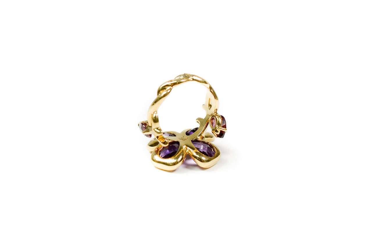 Brand: Chanel 

Style:Camelia Amethyst Ring

Metal:18k Yellow Gold . 

Stones: Amethyst stones. 

Age: 1970's

Ring Size: 8

Stamped Hallmarks: Chanel 13m 225 750