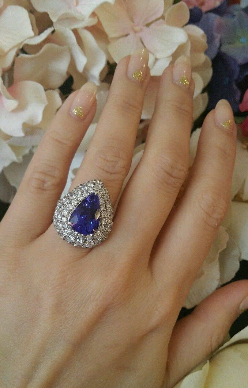 Pear shaped Tanzanite in the center weighing 6.54 ct with very nice and lively Violet-Blue color.  Three-tiered diamond platinum setting contains 79 round brilliant diamonds totaling 3.97 ct, VS2-SI1 clarity and H color.
Ring Size 5.5
Hallmarks: