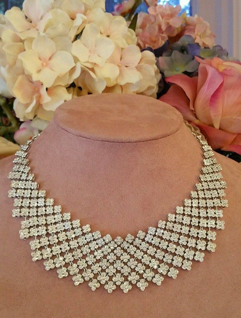 Beautiful tapered bib necklace showcasing an intricate  trellis work constructed with four-petal florets design. Necklace contains over 20 cts of diamonds with 870 Round Brilliant diamonds.  
Diamonds are all bezel set into individual florets --